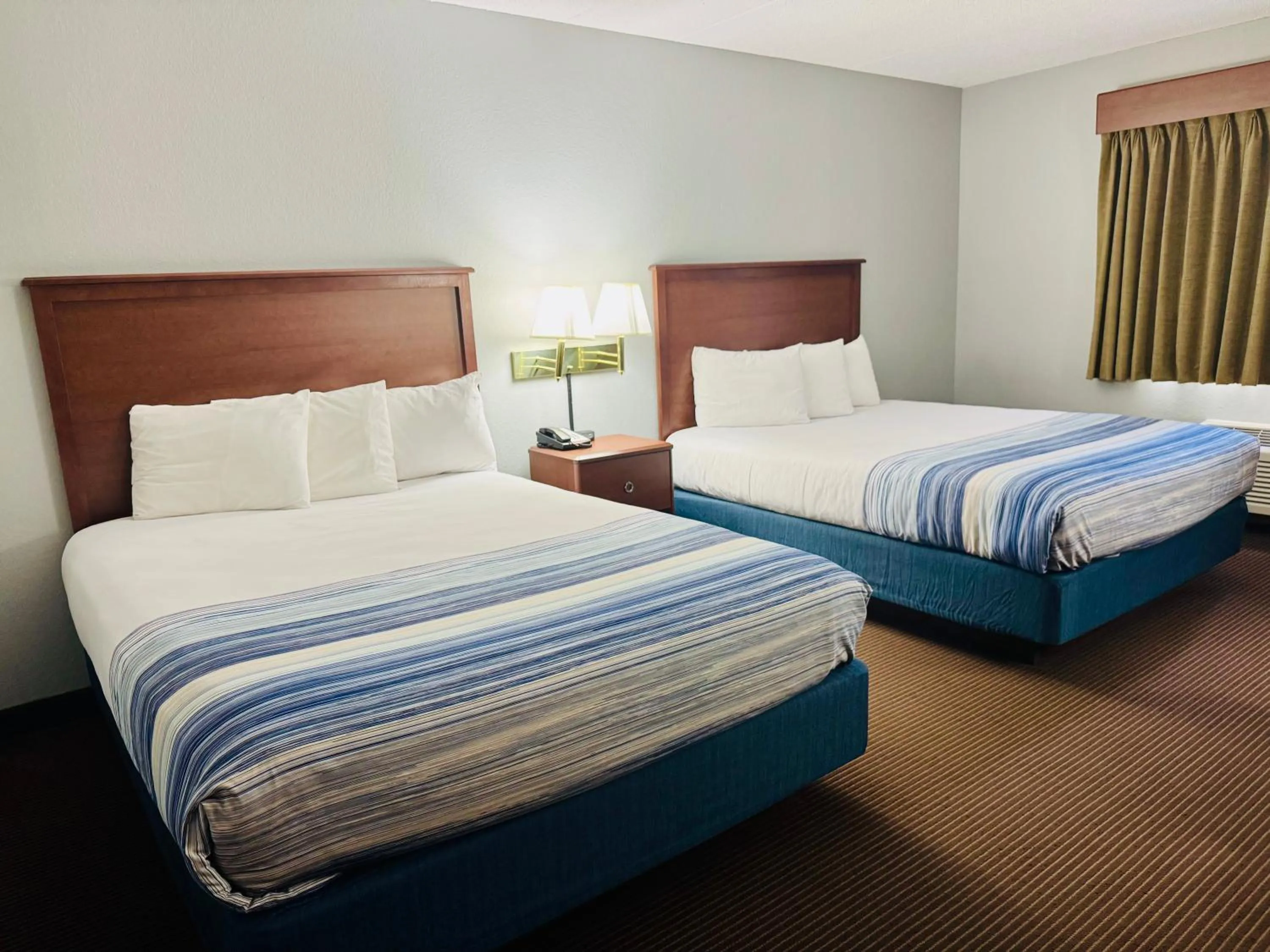 Bed in AmericInn by Wyndham Stillwater