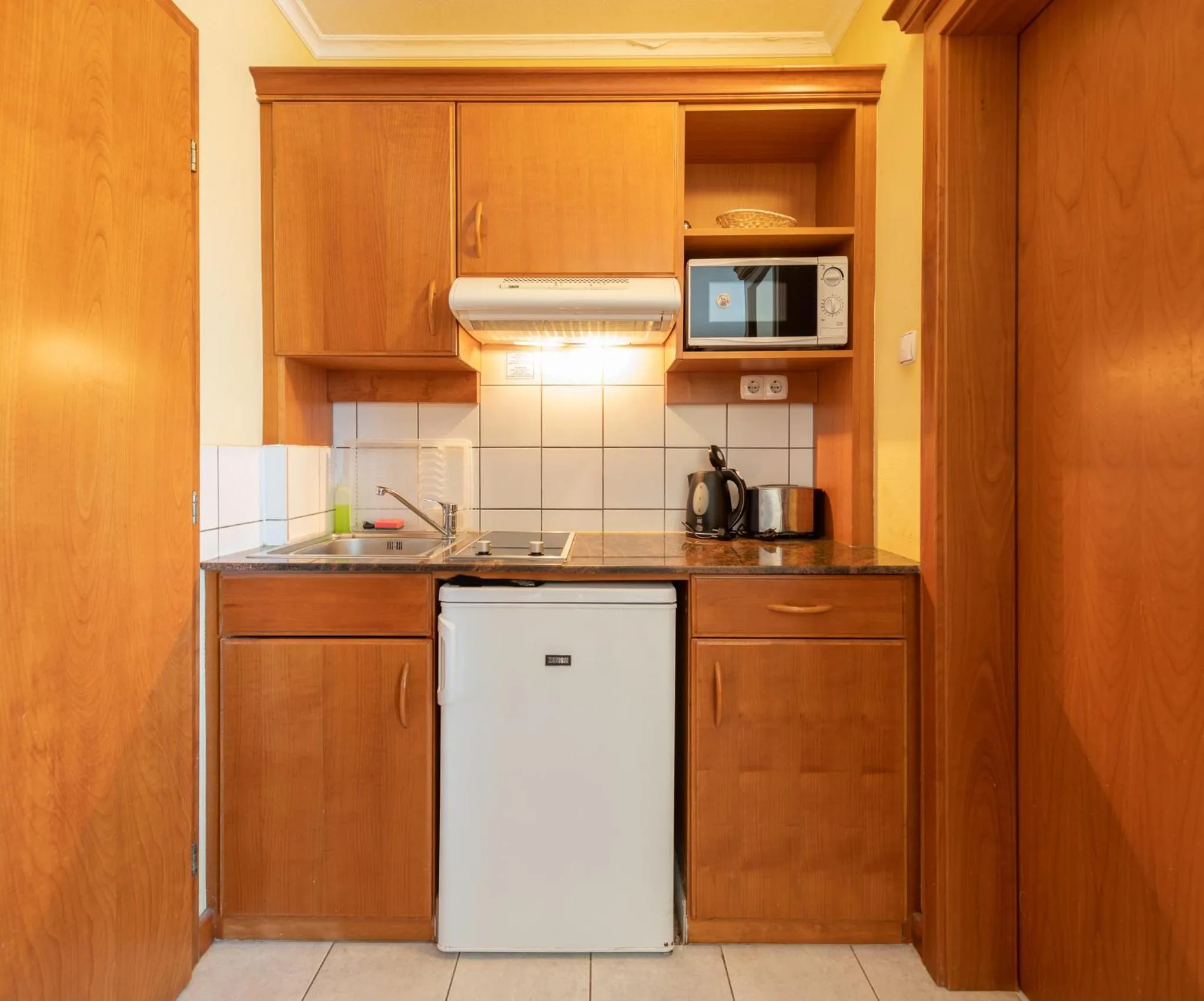Kitchen or kitchenette in Holiday Club Apartman Hotel