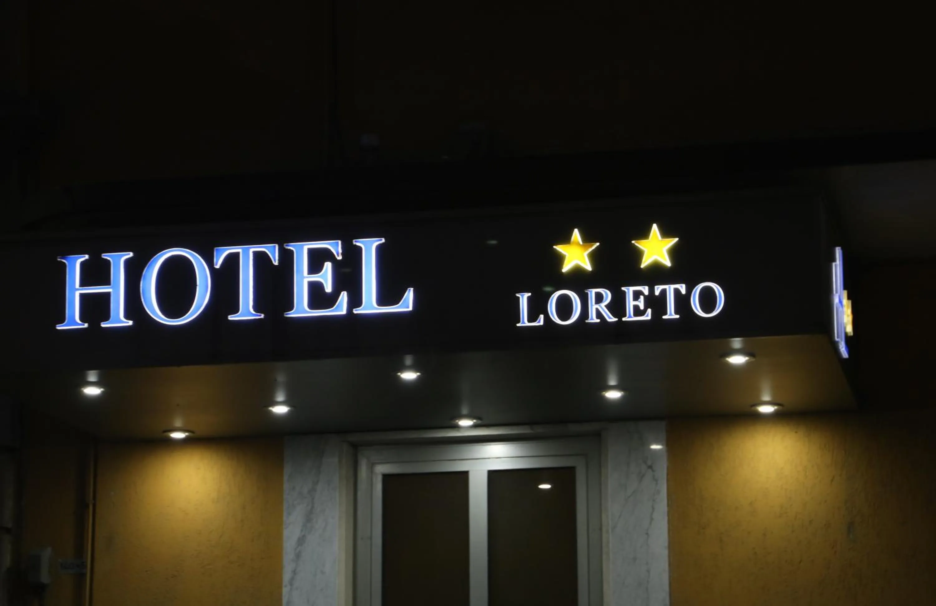 Property logo or sign in Hotel Loreto