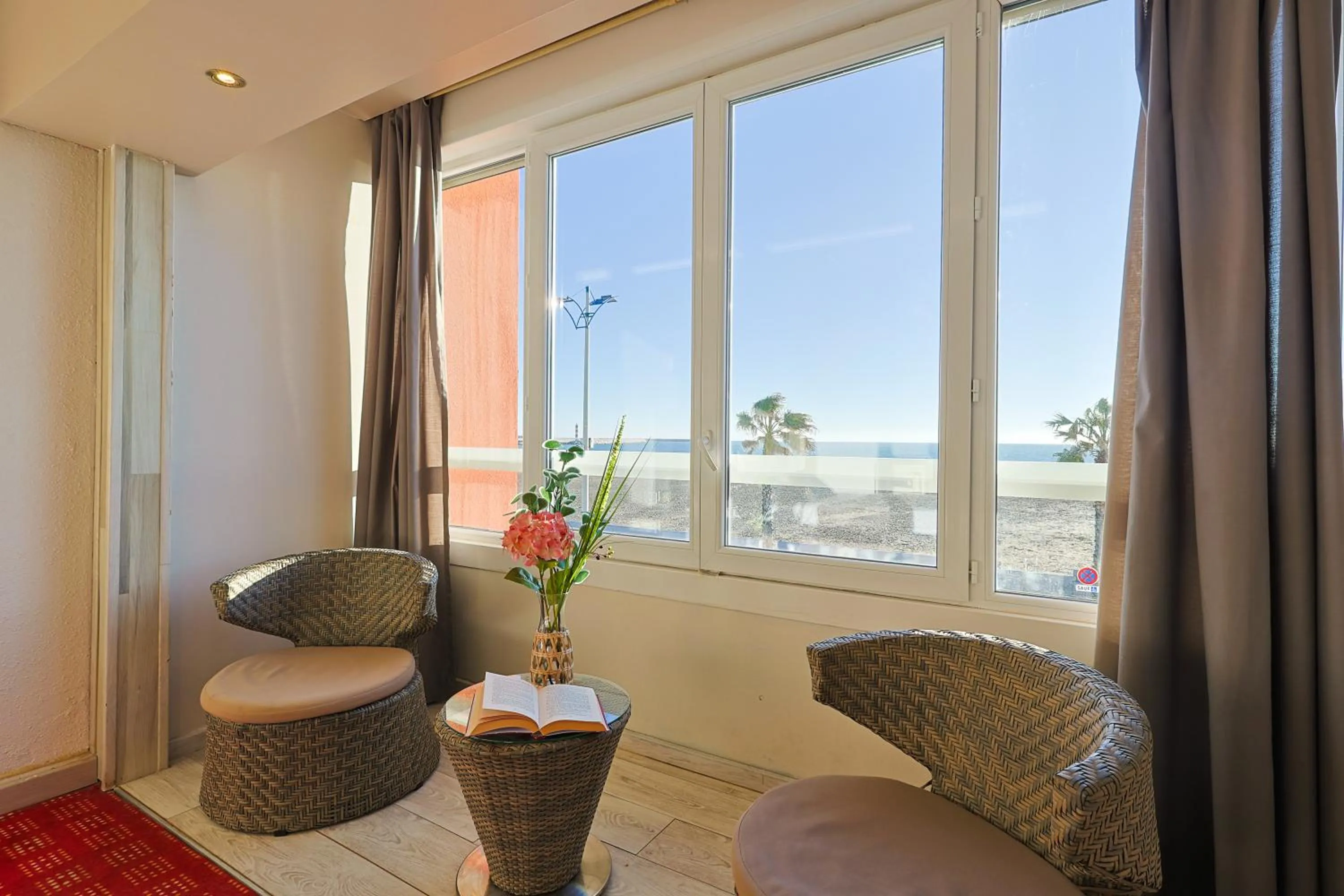 Seating area in Logis Hôtel & Restaurant Mediterranee