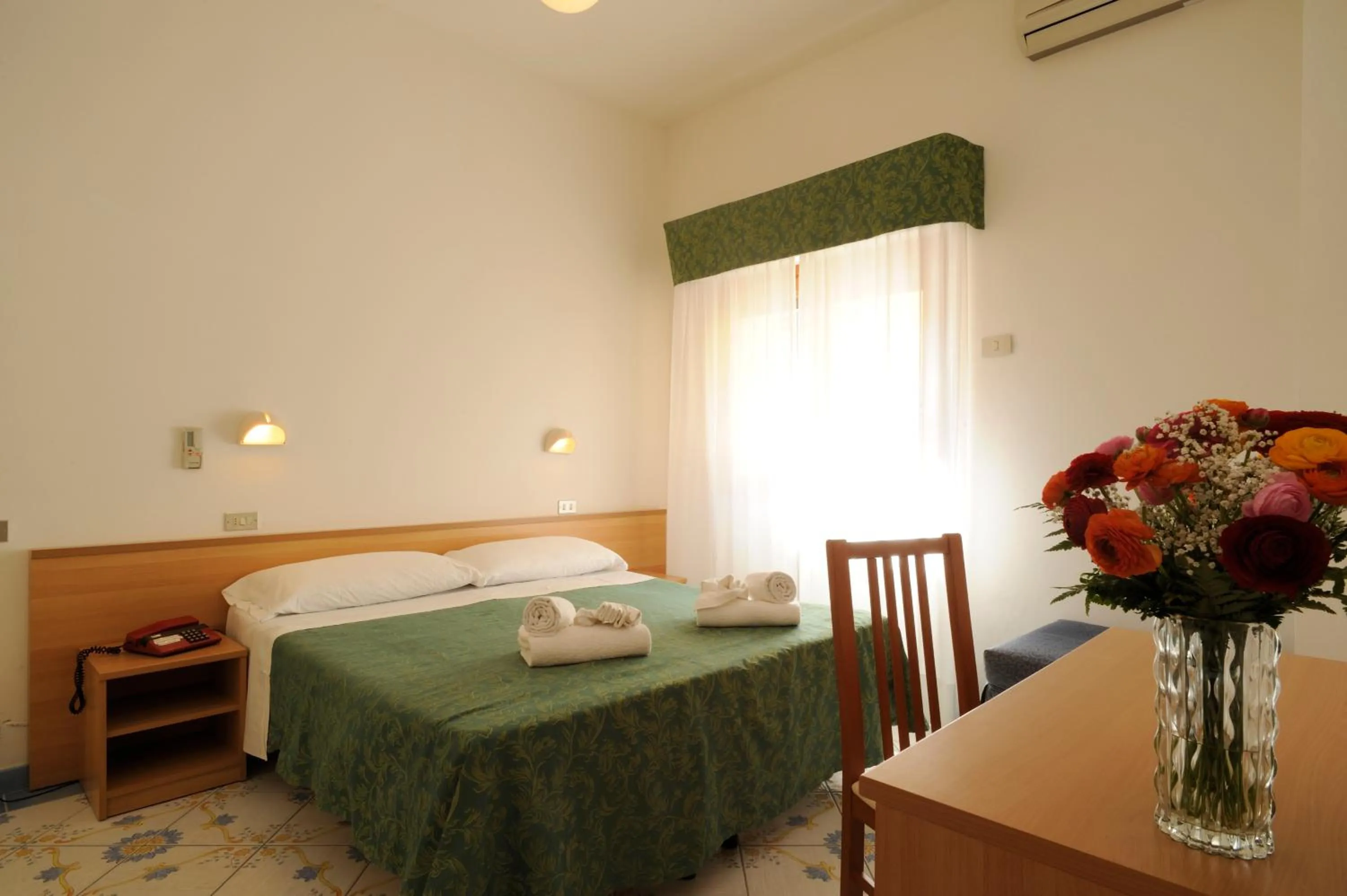 Bed in Hotel Delfino