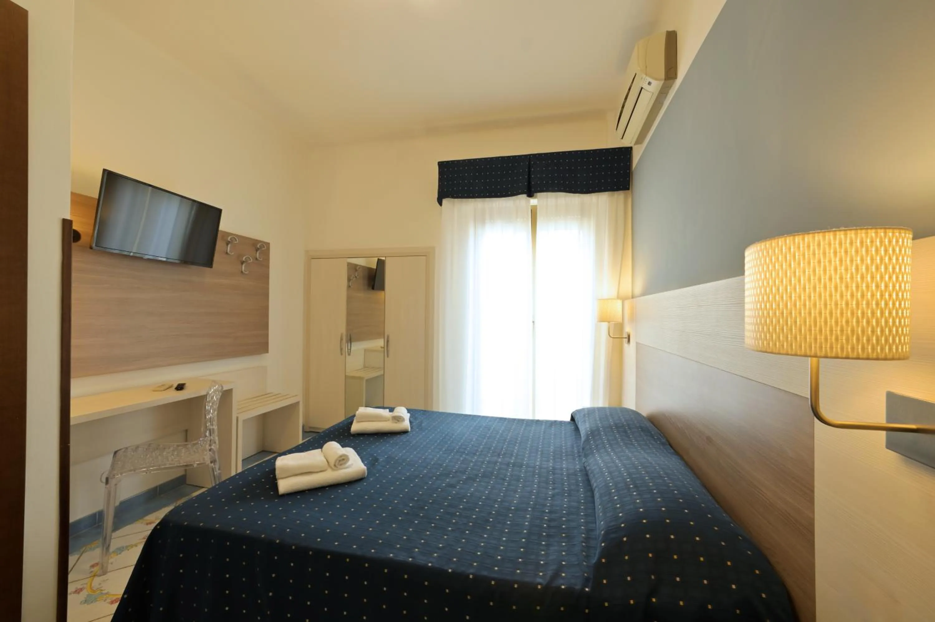 Bed in Hotel Delfino