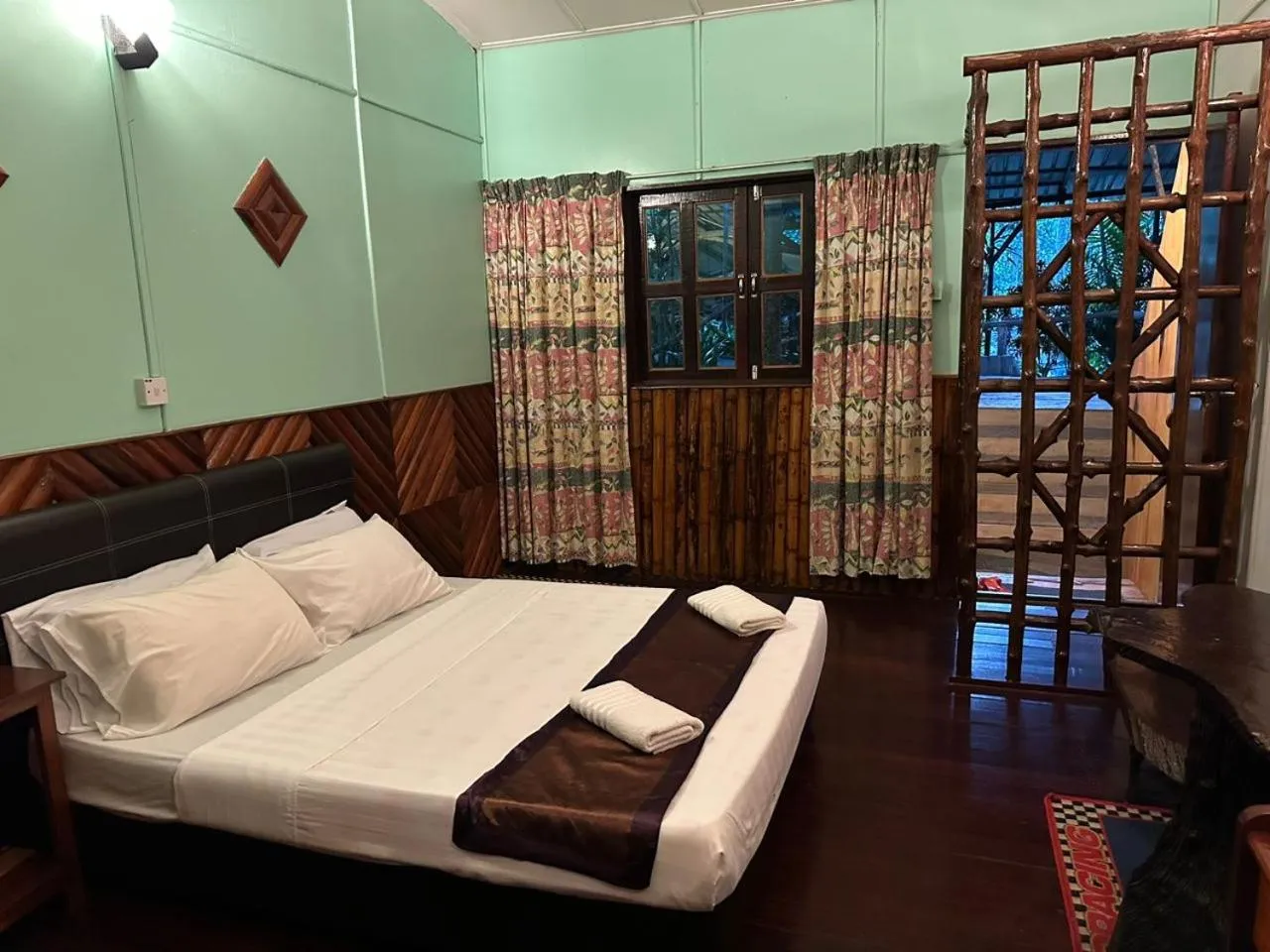 Bed in Sepilok Jungle Resort