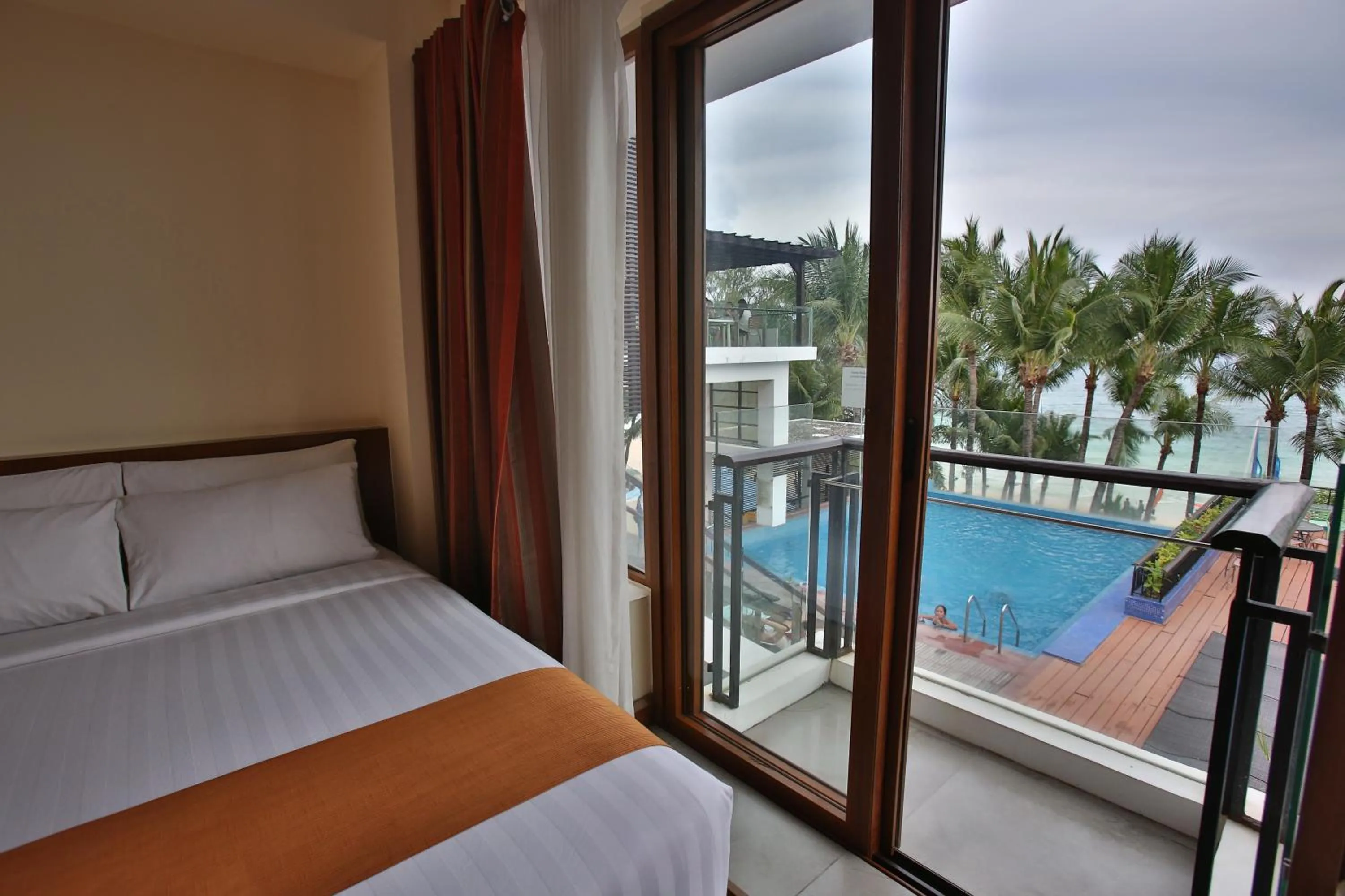 Balcony/Terrace, Bed in Crown Regency Beach Resort