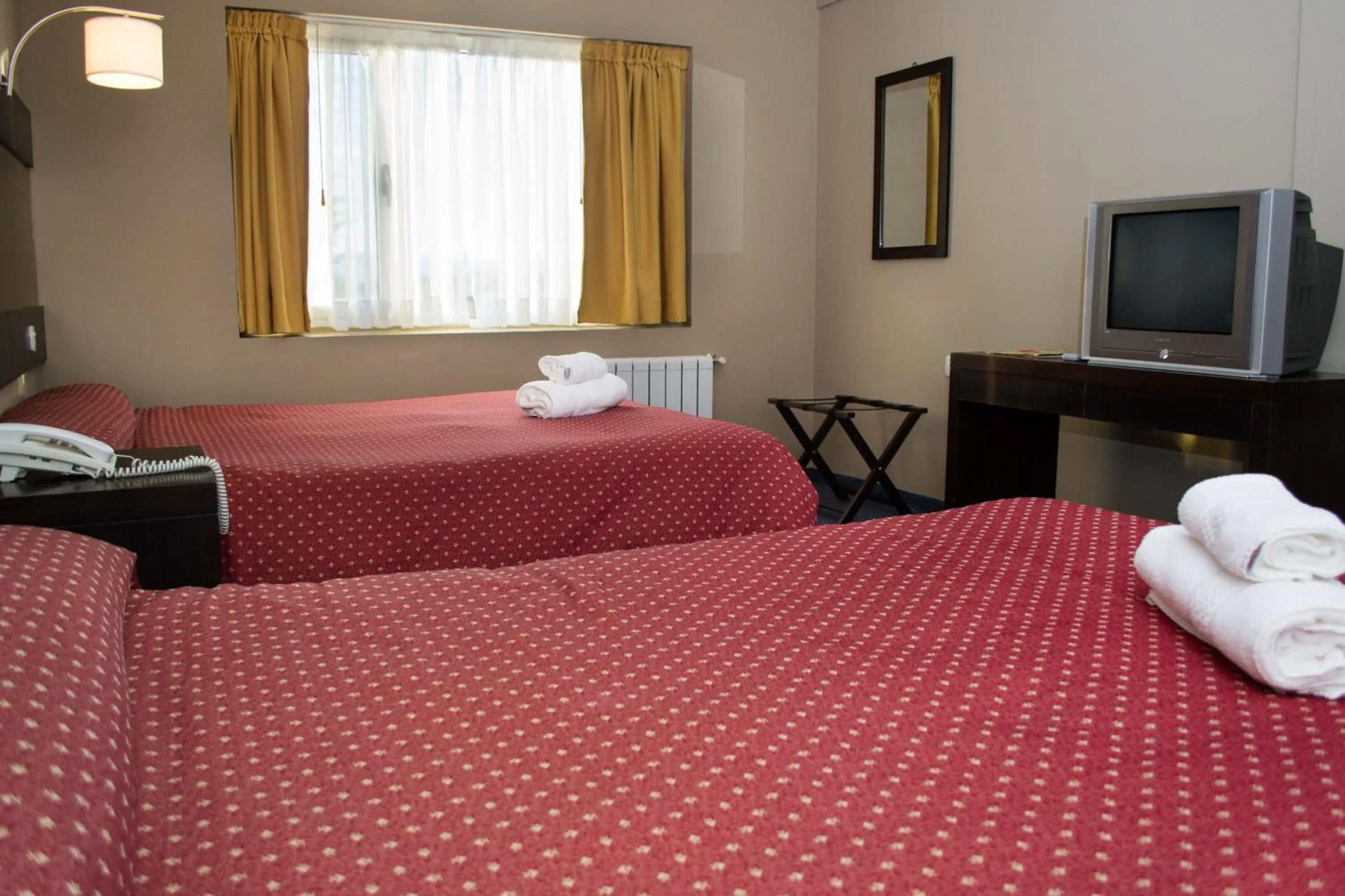 Bed in Marcopolo Suites Calafate