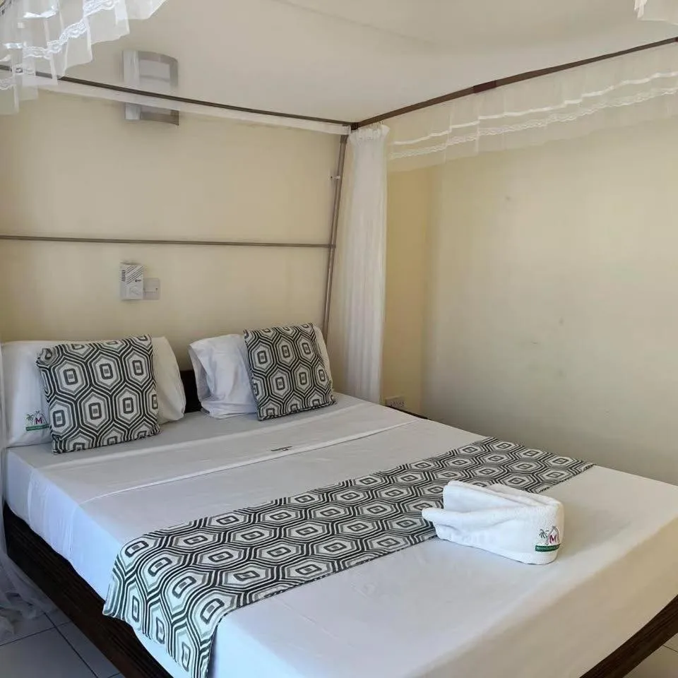 Bed in Merry Villa Hotel & Apartments