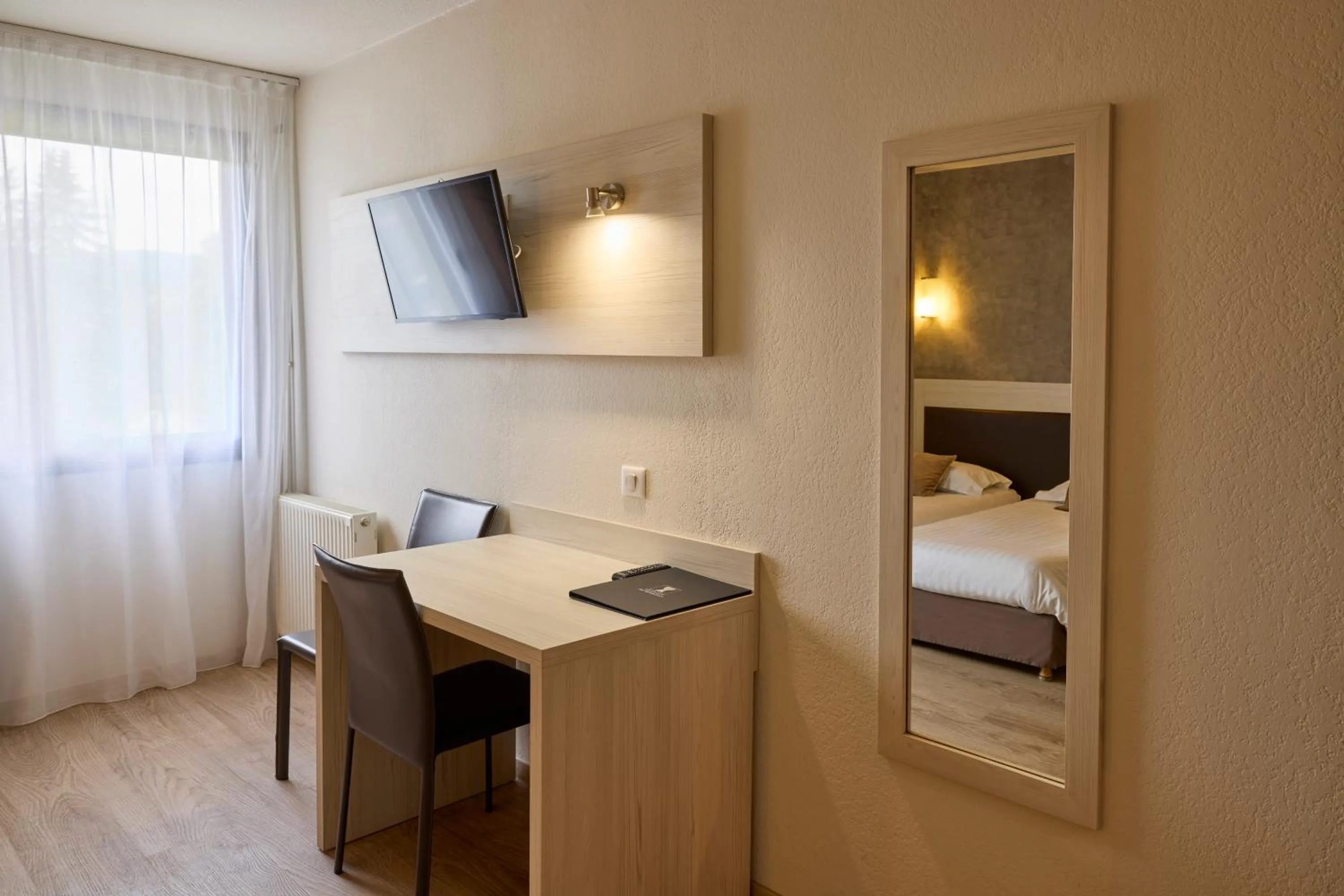 Photo of the whole room, Bed in Hôtel-Restaurant Le Calice Du Gevaudan - A75