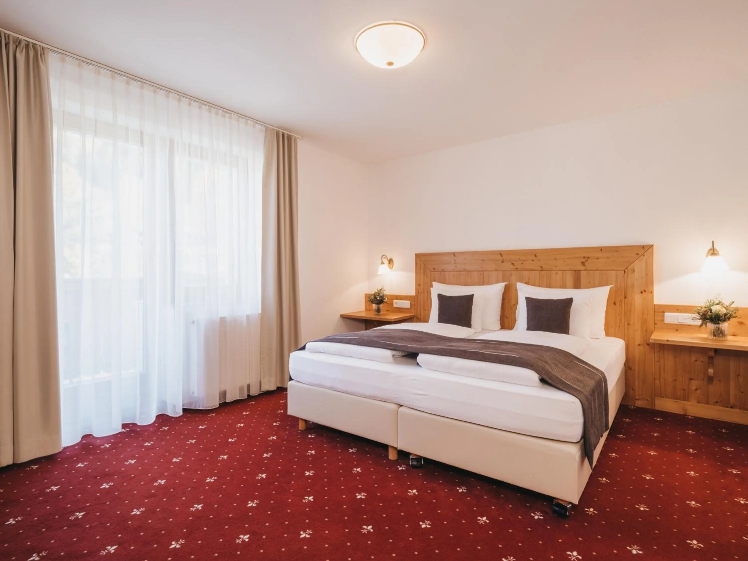 Bed in Hotel Vier Jahreszeiten by VAYA