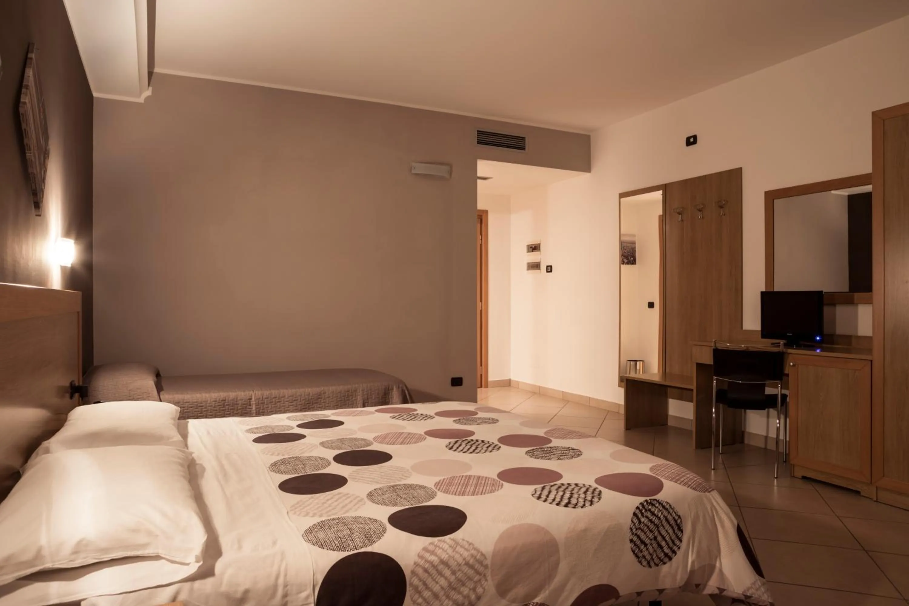 Bed in Manhattan Village Hotel