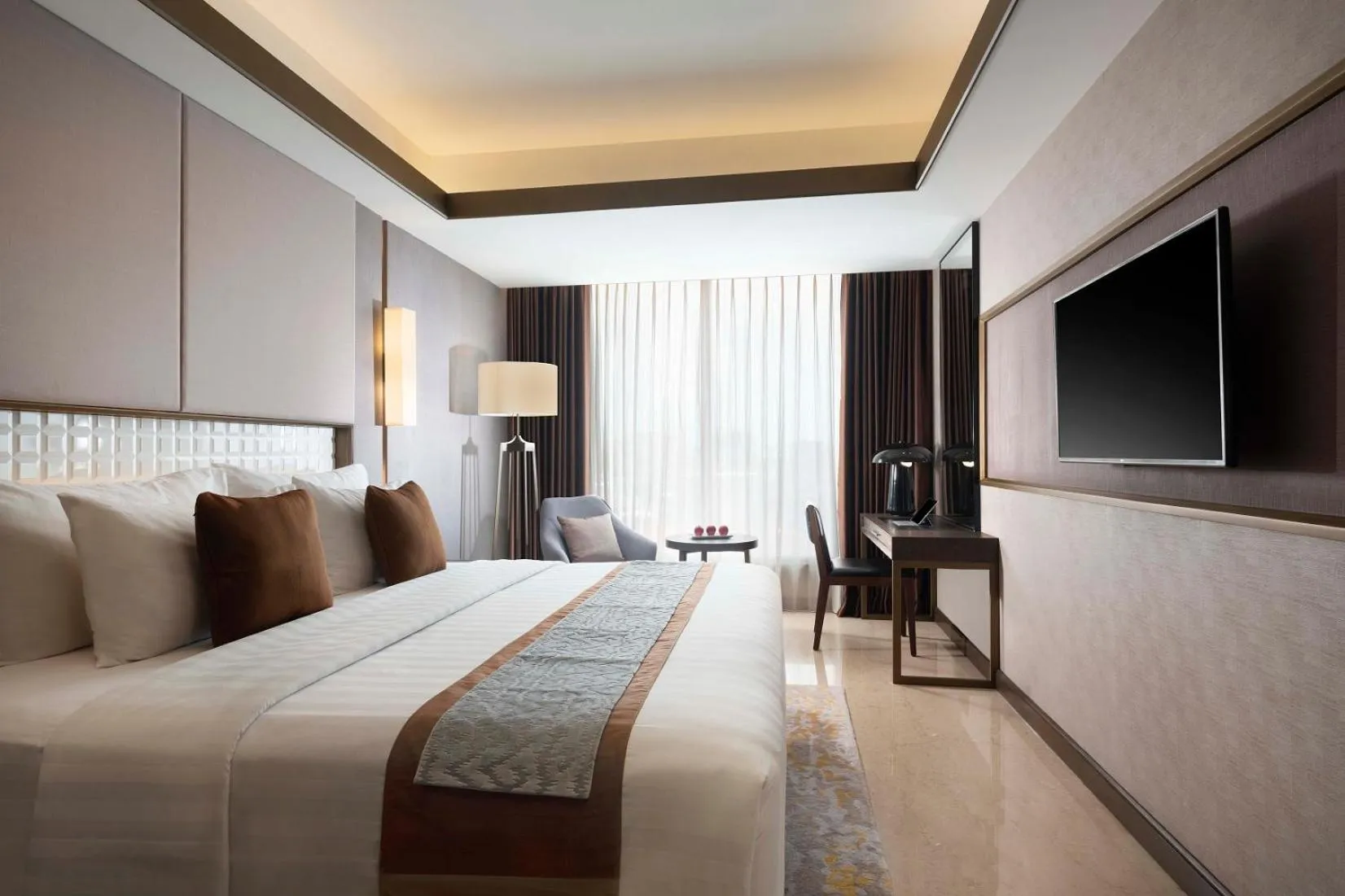 Bed in GRAMM HOTEL by Ambarrukmo Yogyakarta