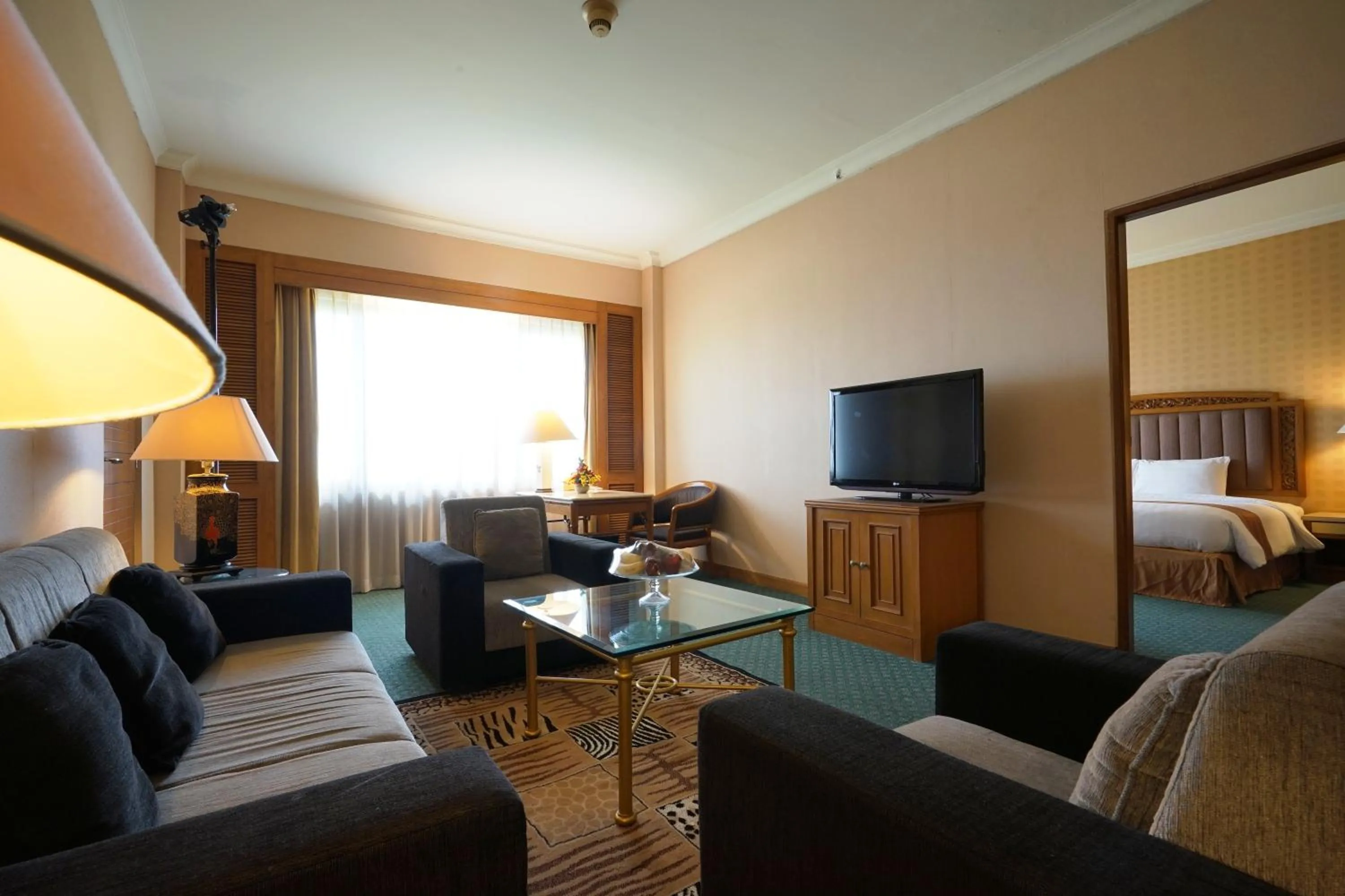 Living room, Bed in Grand Diamond Hotel Yogyakarta