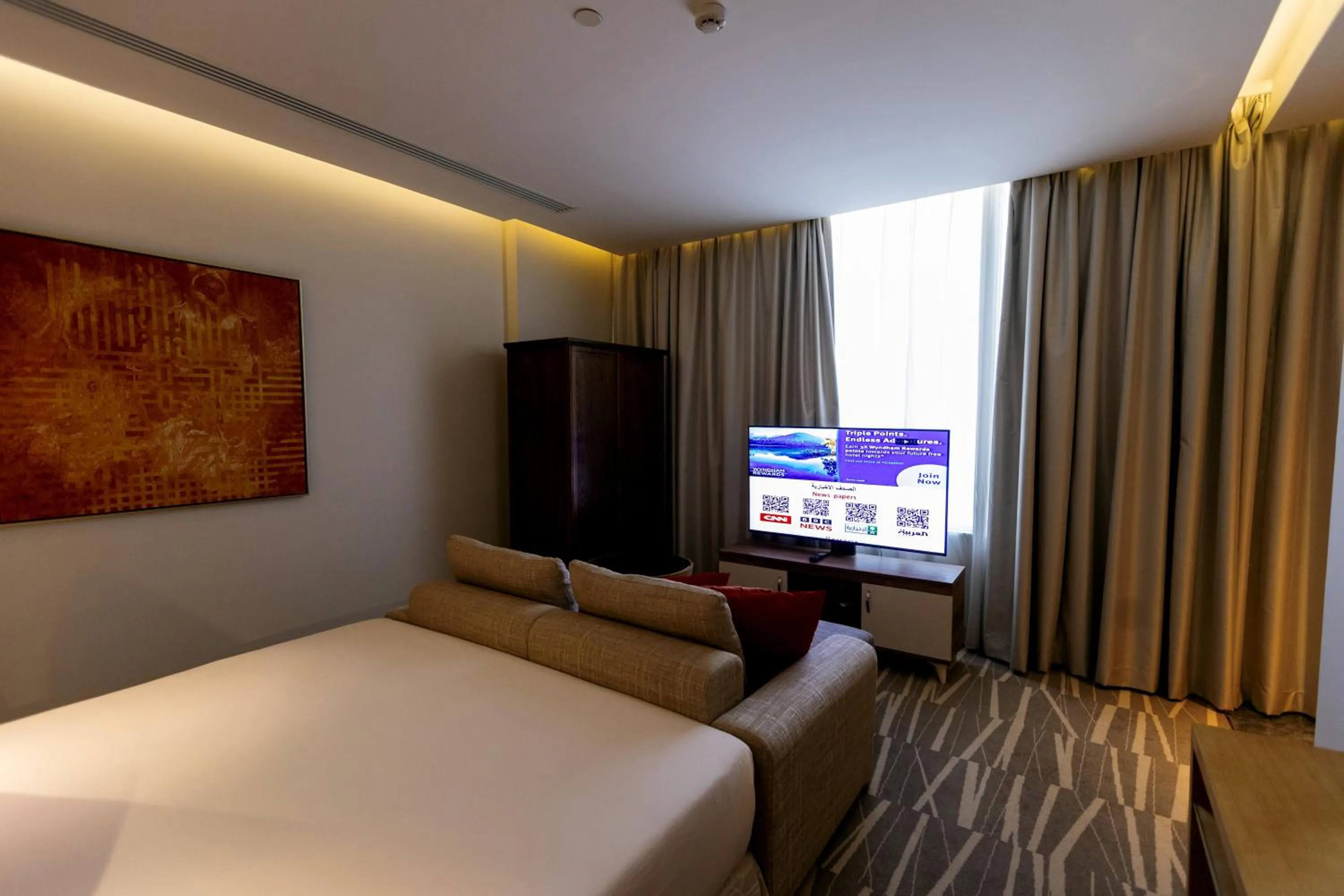 Bedroom, Bed in Ramada Hotel & Suites by Wyndham Al Qassim