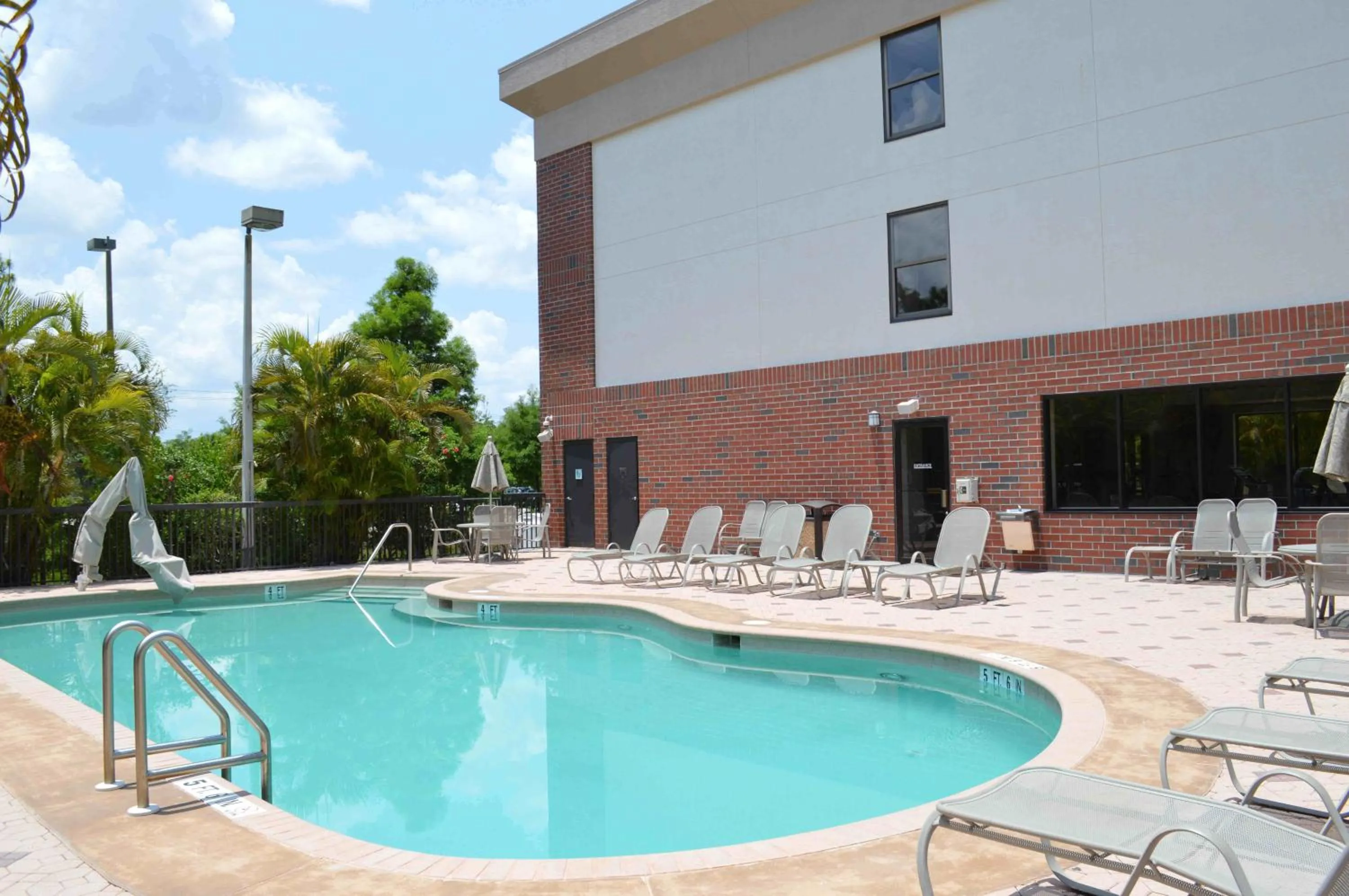 Swimming pool in Days Inn & Suites by Wyndham Fort Myers Near JetBlue Park
