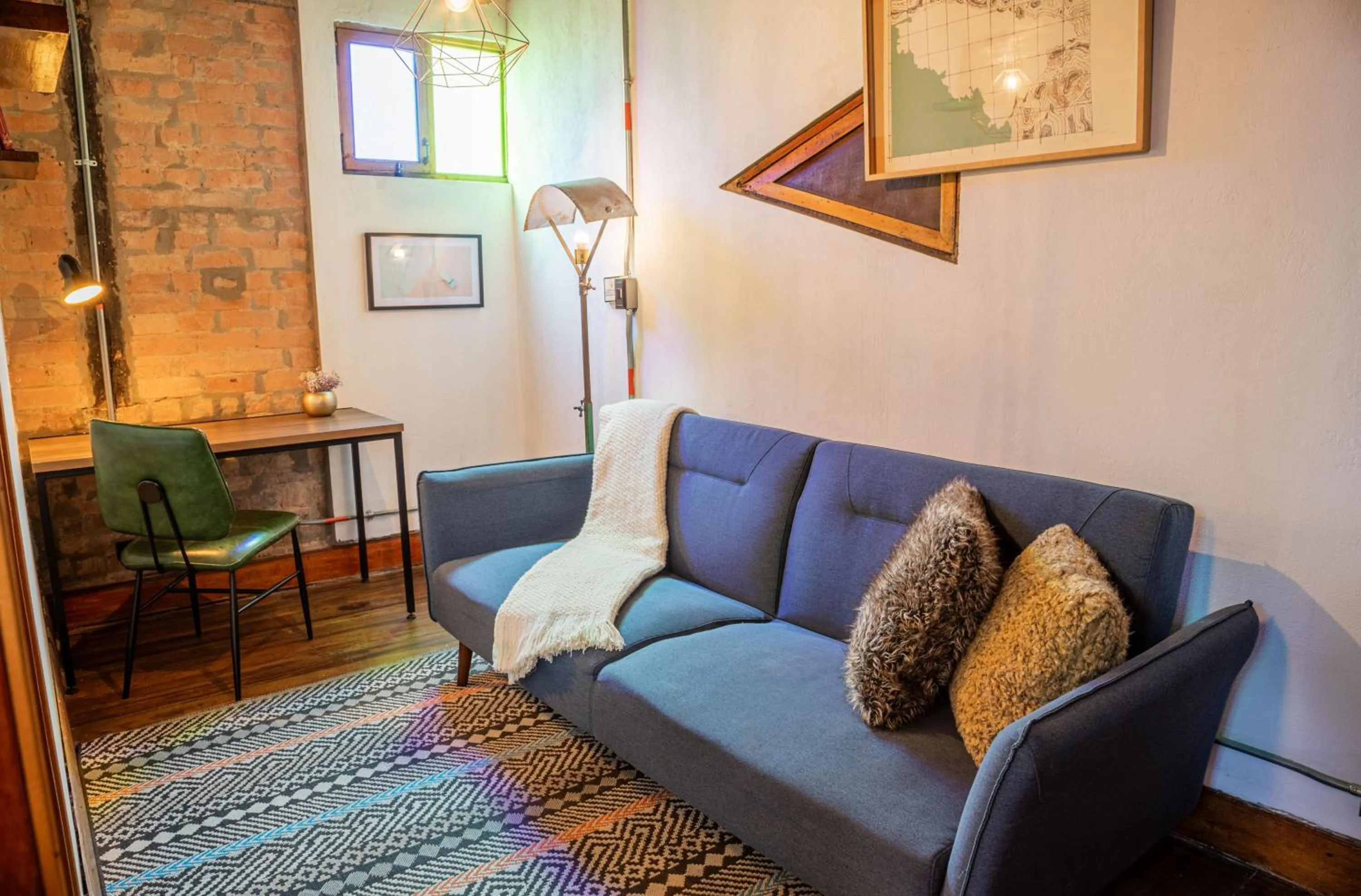 Living room in Delgadillo Hotel by Socialtel