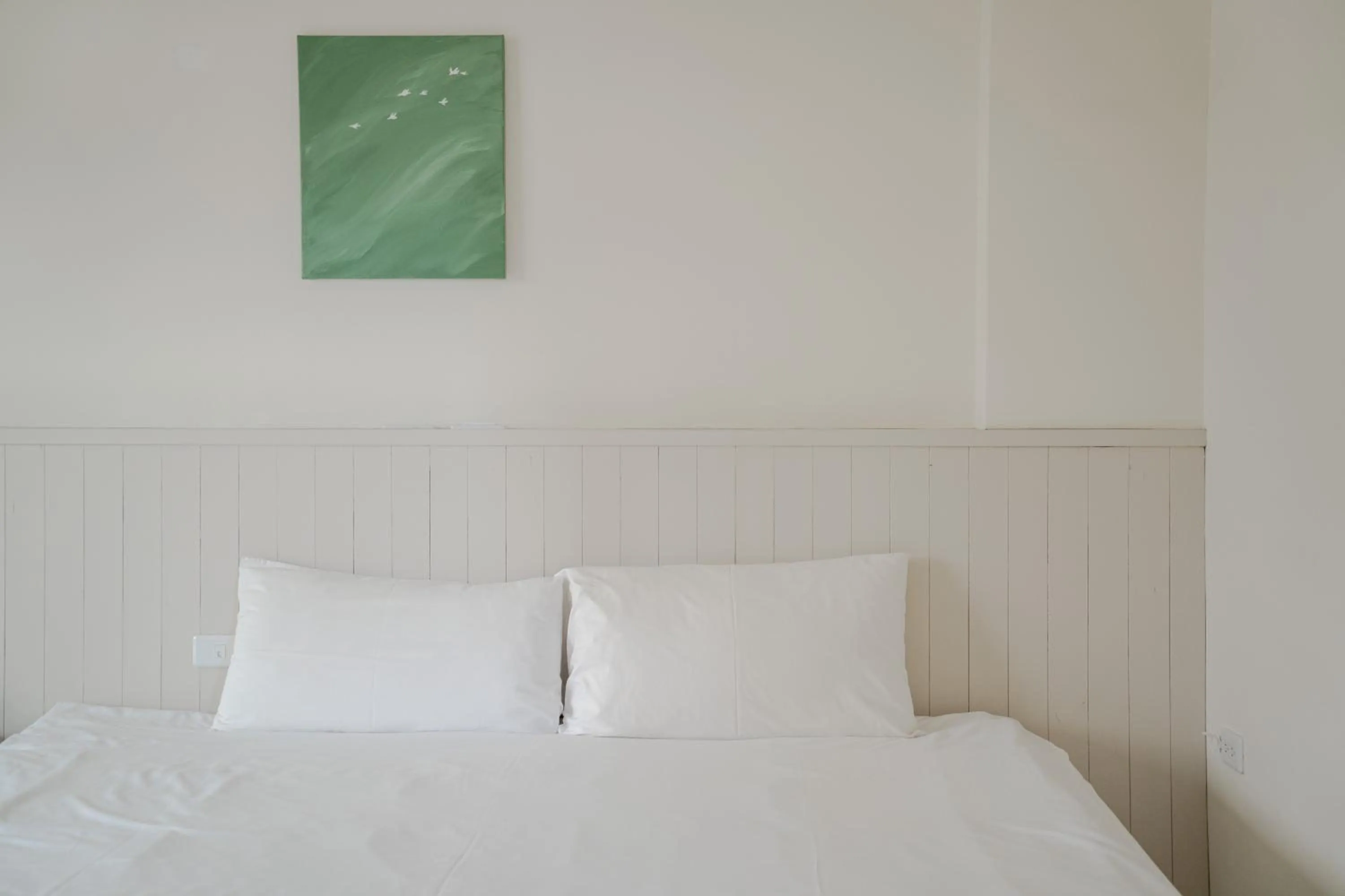 Bed in Cozy Green Guesthouse