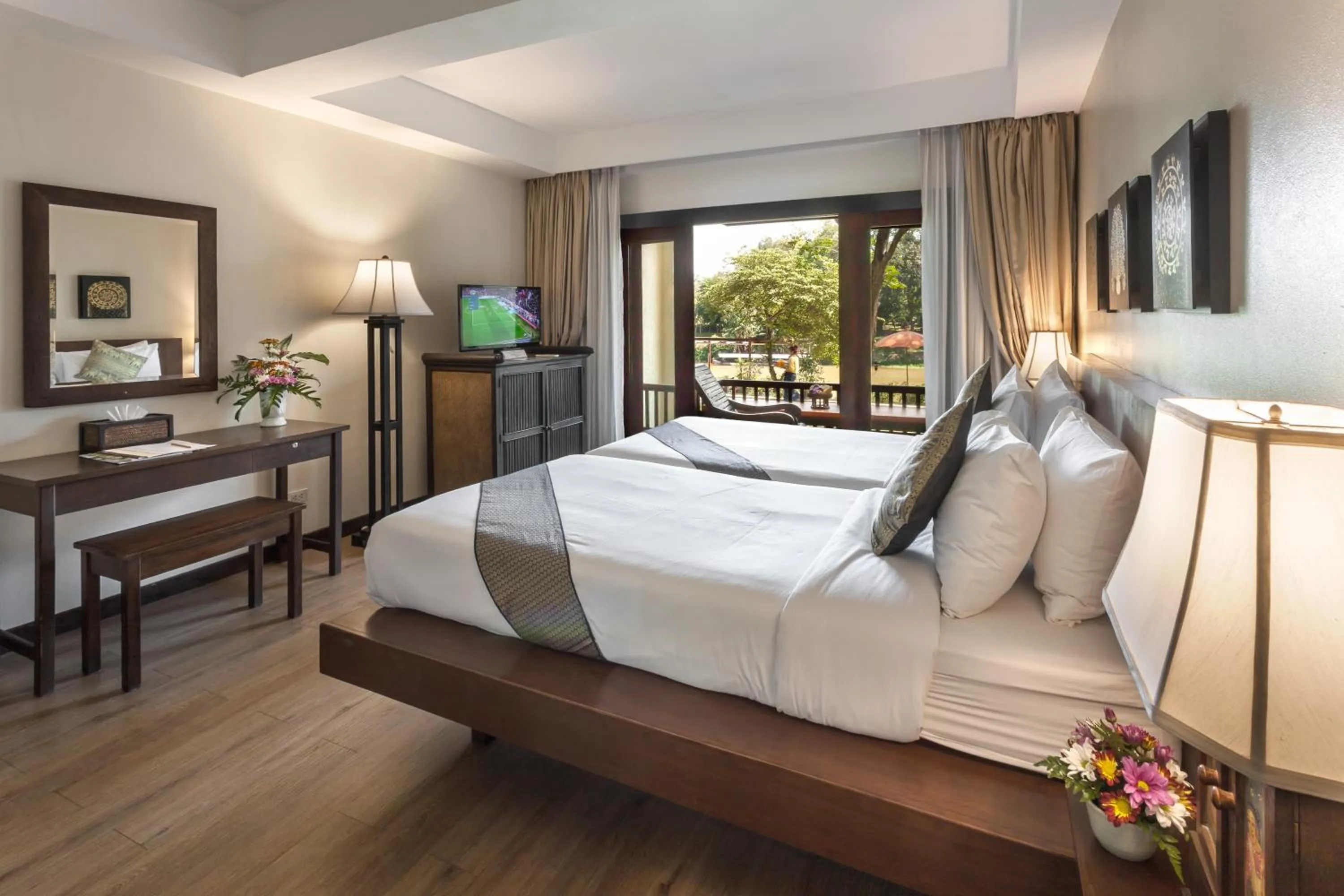 Bed in Lanna Dusita Riverside Boutique Resort