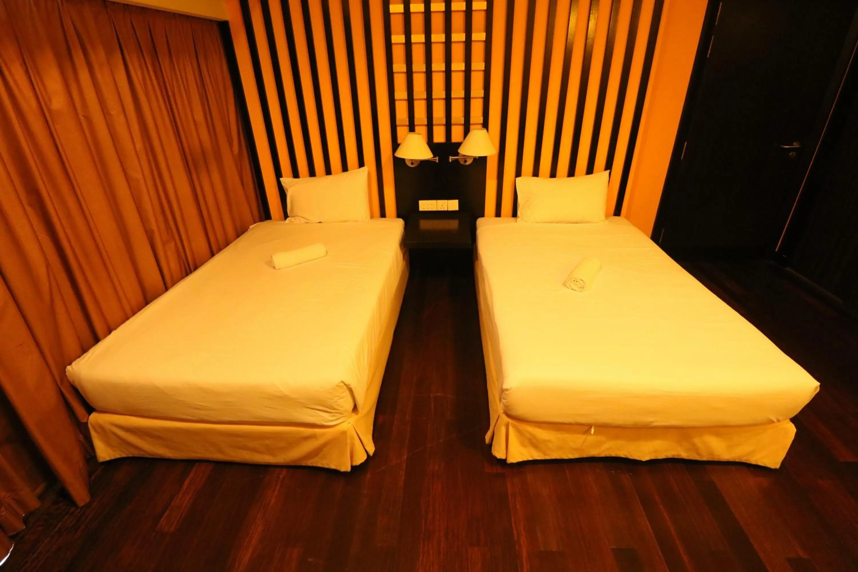 Bed in Raintree Resort Suites