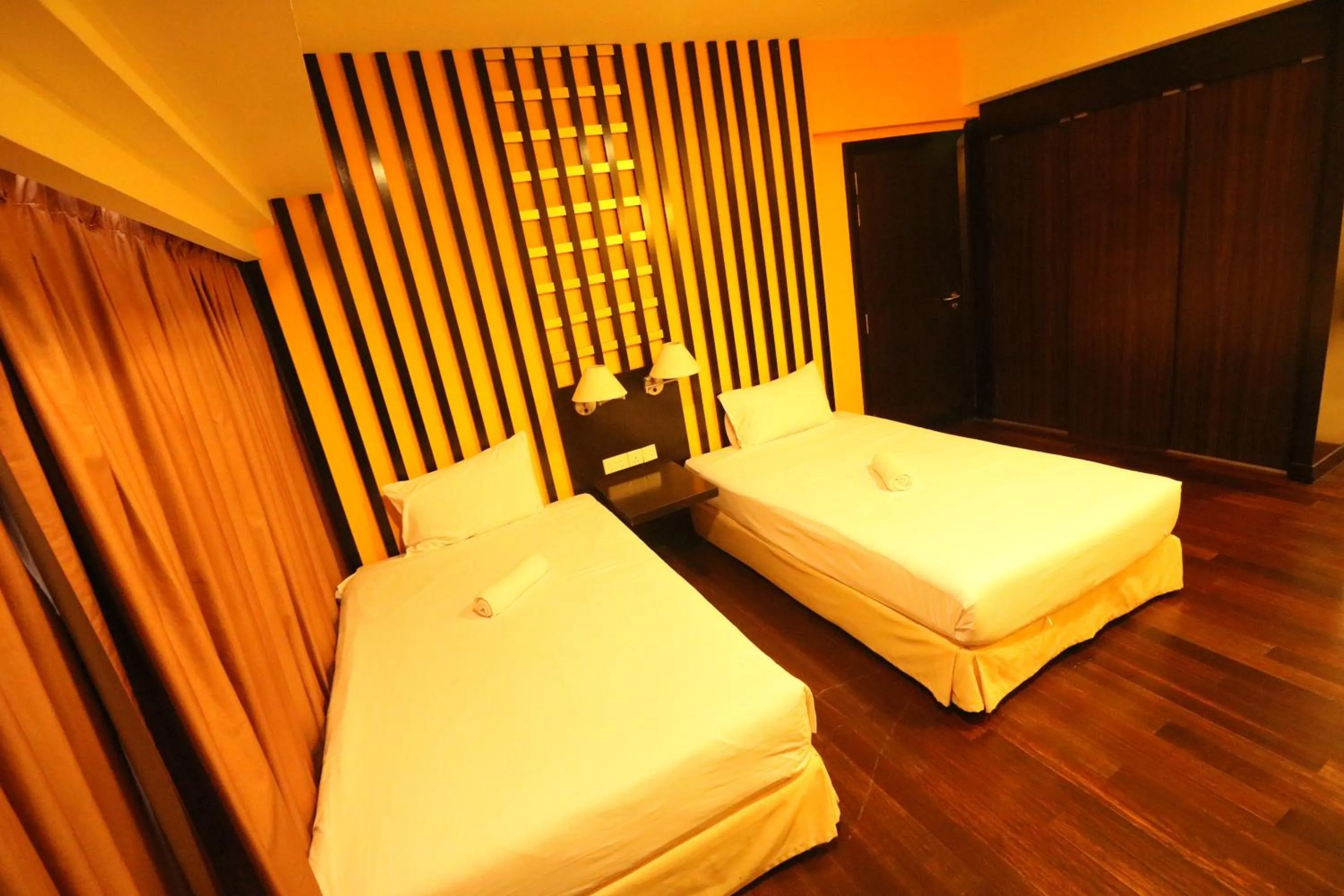 Bed in Raintree Resort Suites