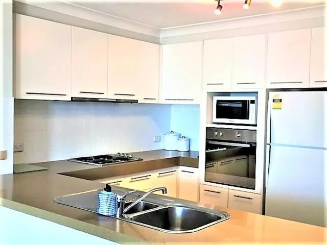 Kitchen or kitchenette in Genesis Apartments by Gold Coast Premium