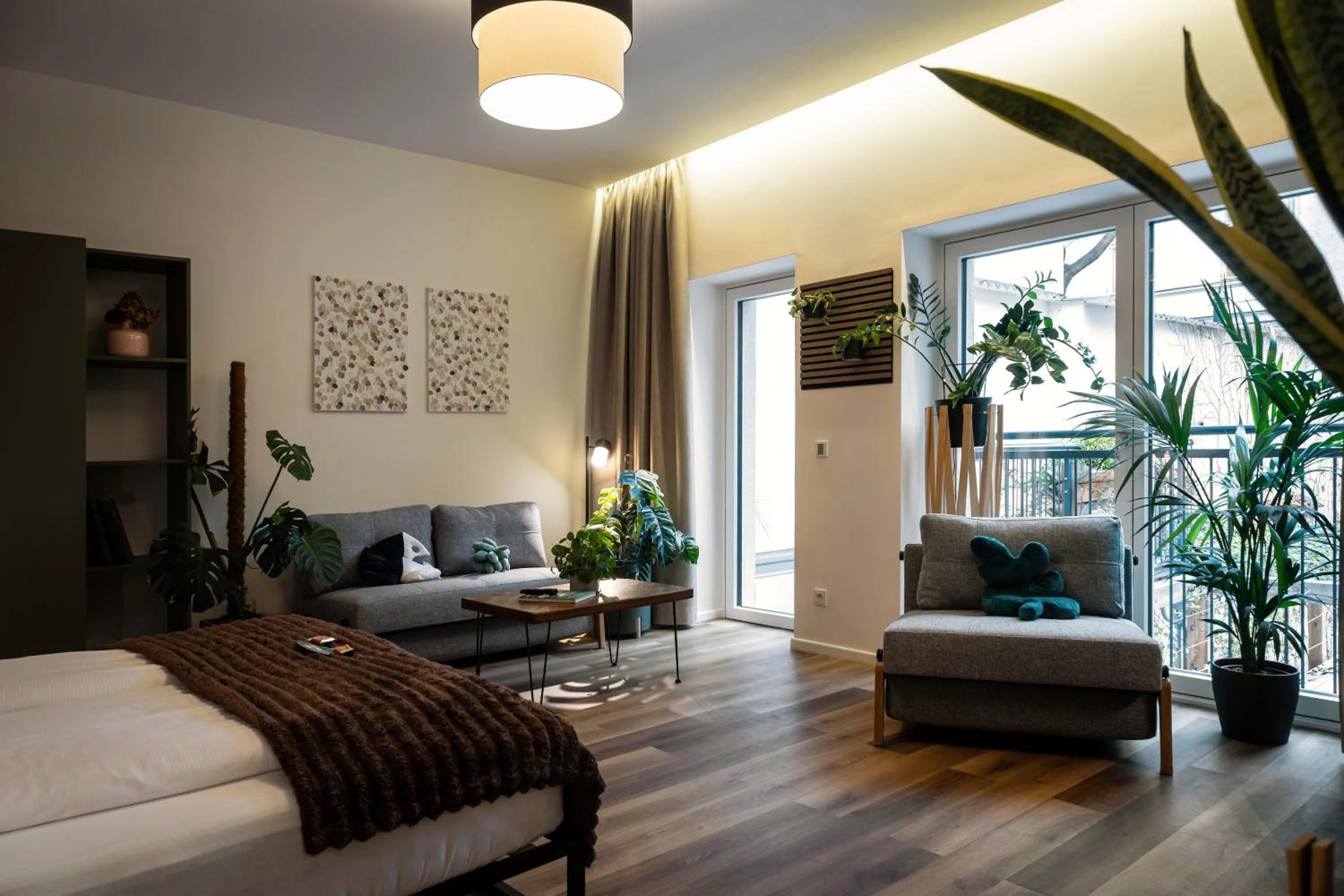 Living room, Bed in Urban Jungle Apartments