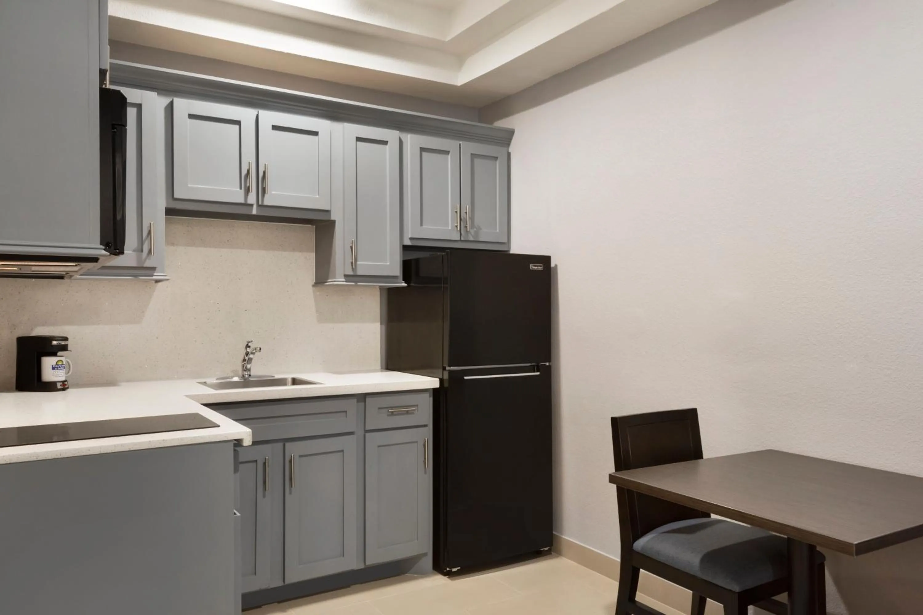 Kitchen or kitchenette in Days Inn & Suites by Wyndham Houston Hobby Airport