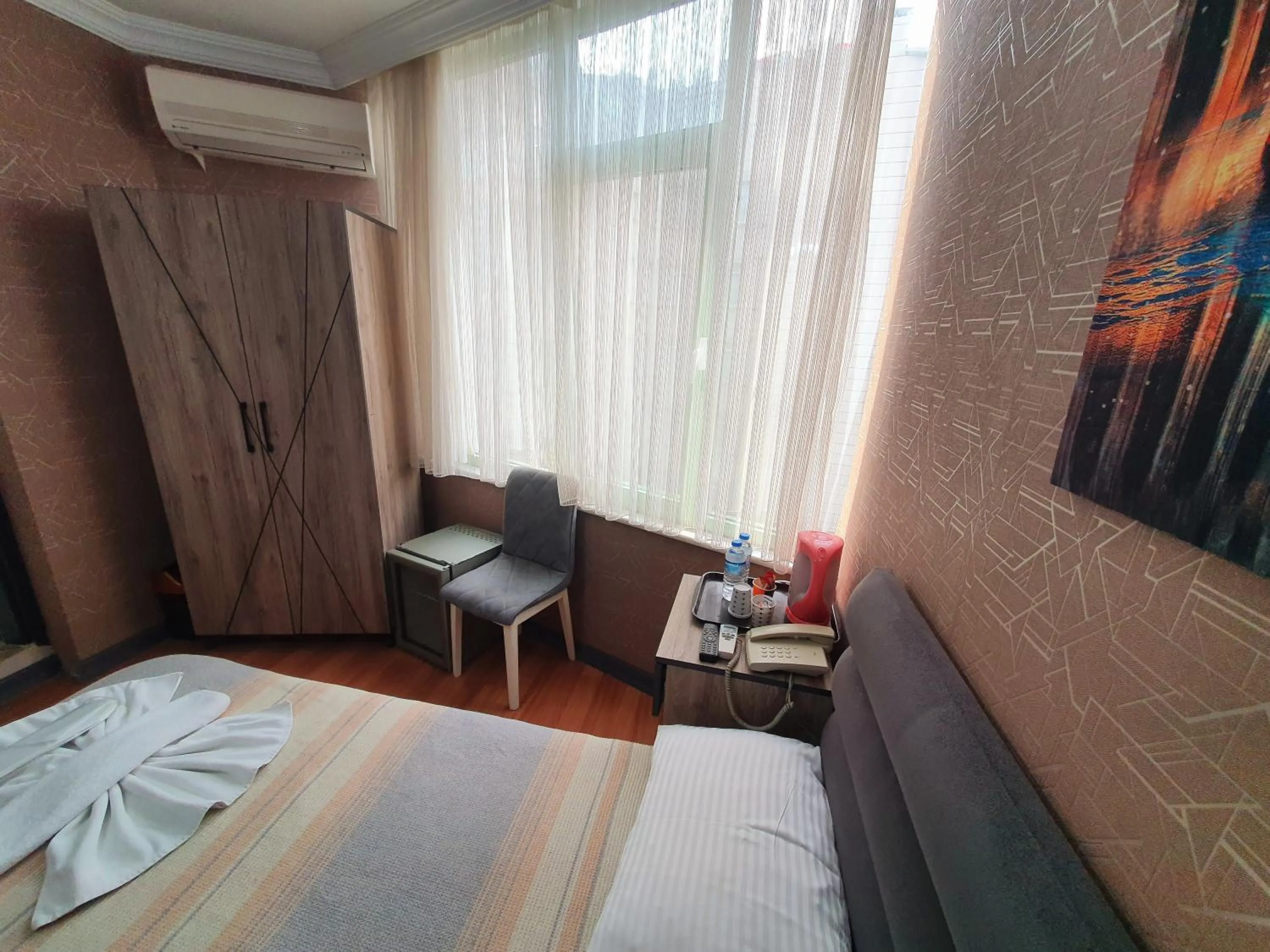 Seating area, Bed in Omega Luxx Hotel