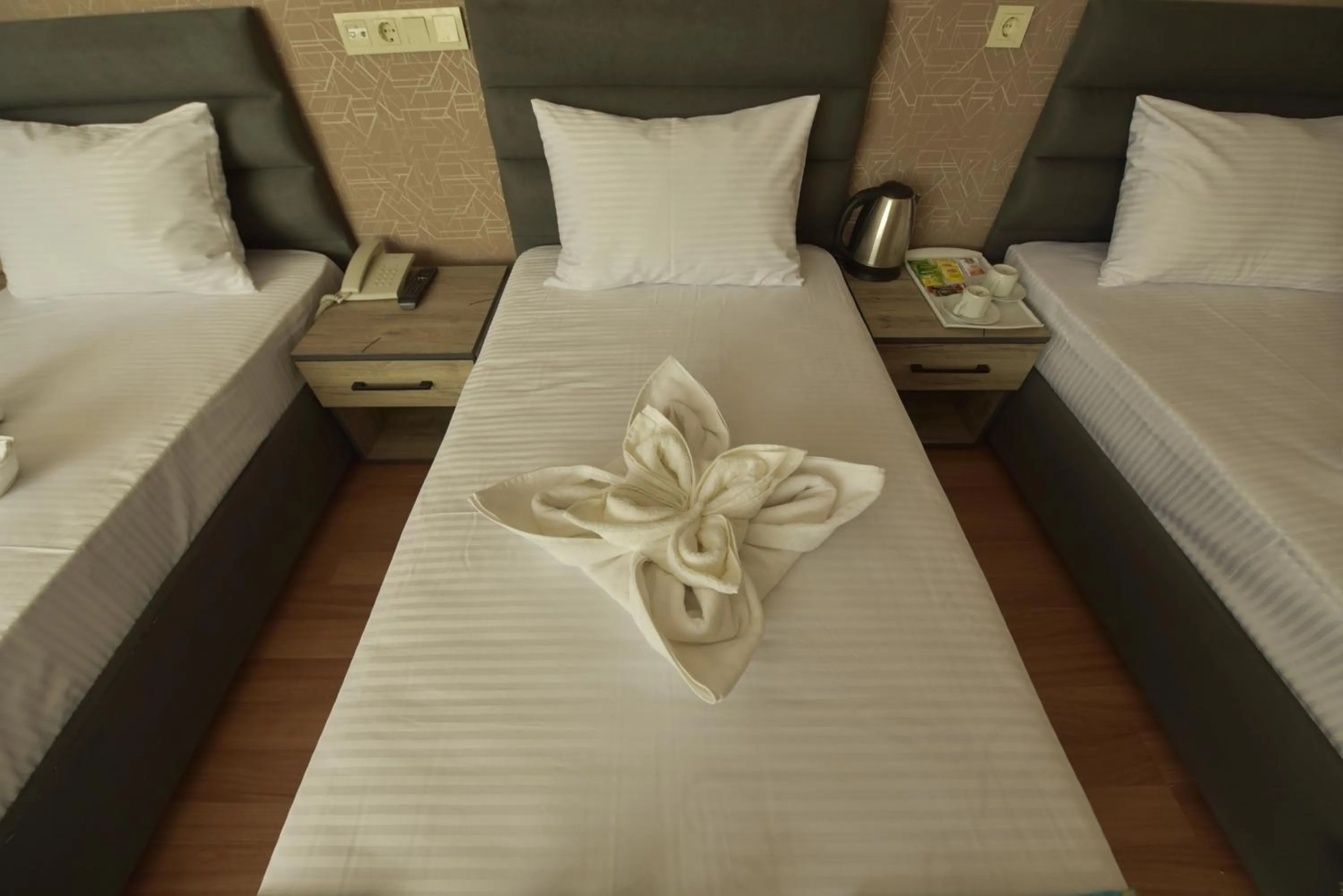 Bed in Omega Luxx Hotel
