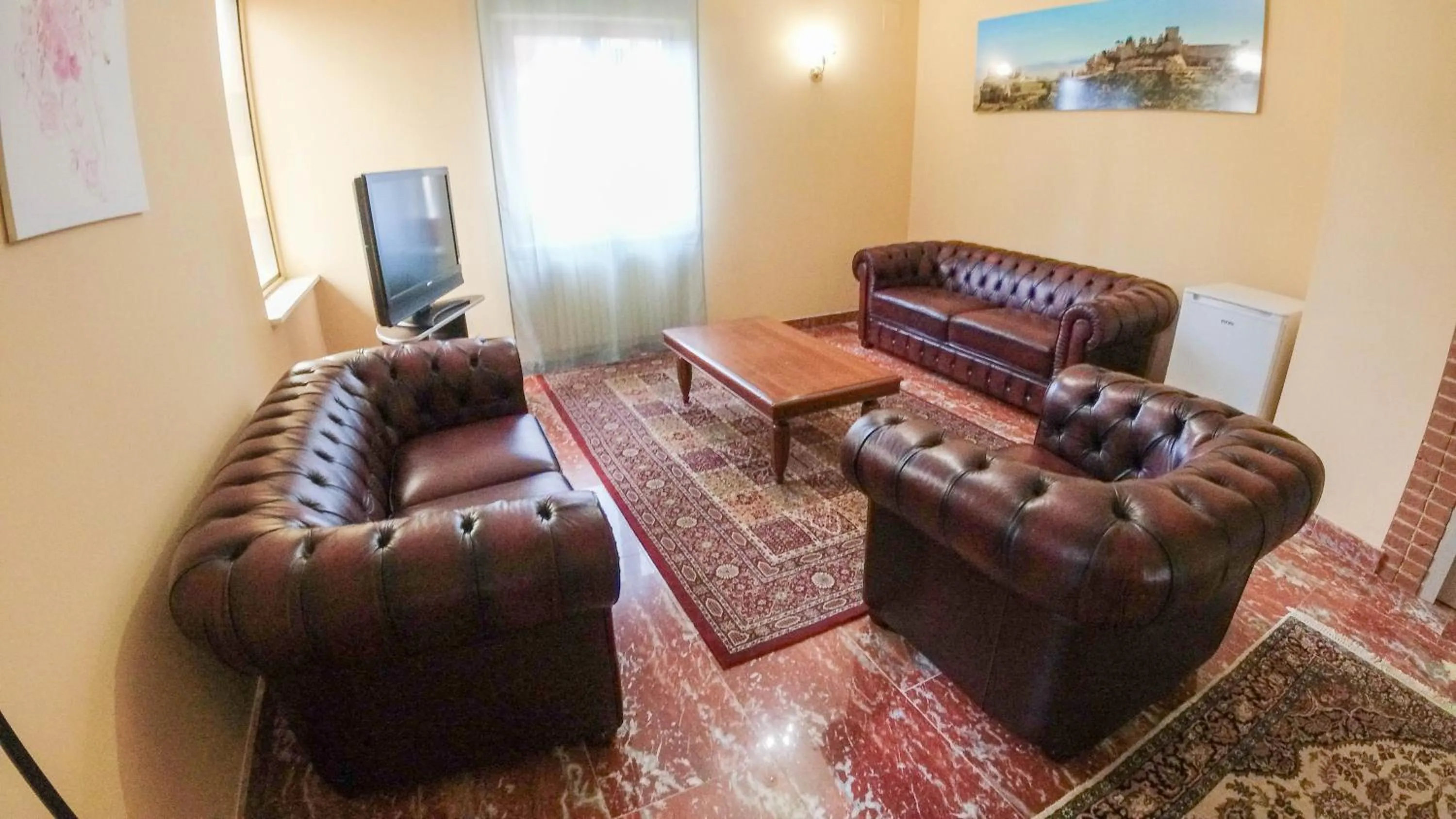 Communal lounge/ TV room in Il Piccolo Hotel