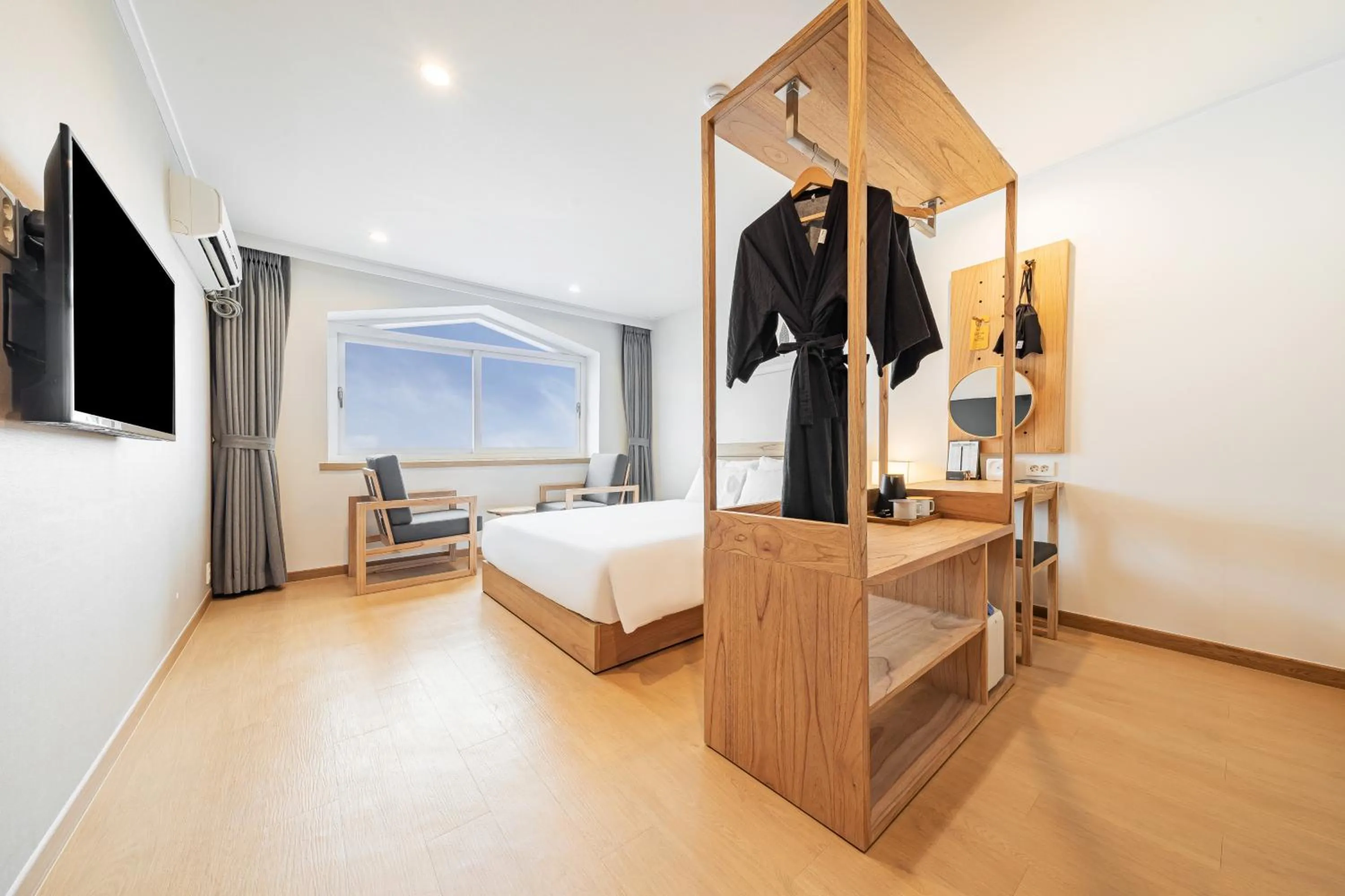 Living room, Bed in Heyy Seogwipo Hotel