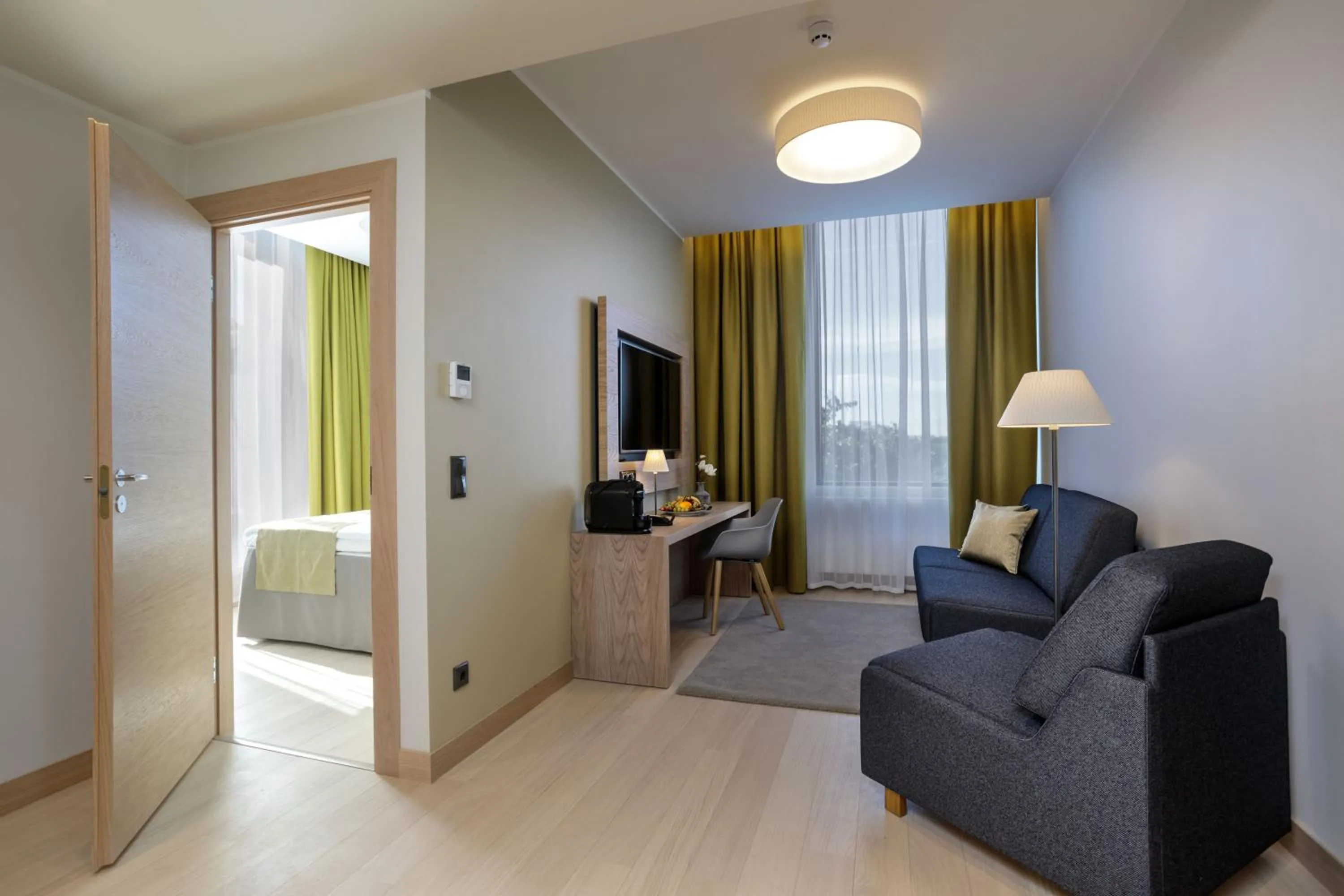 Living room, Bed in Centennial Nexus Hotel Tallinn