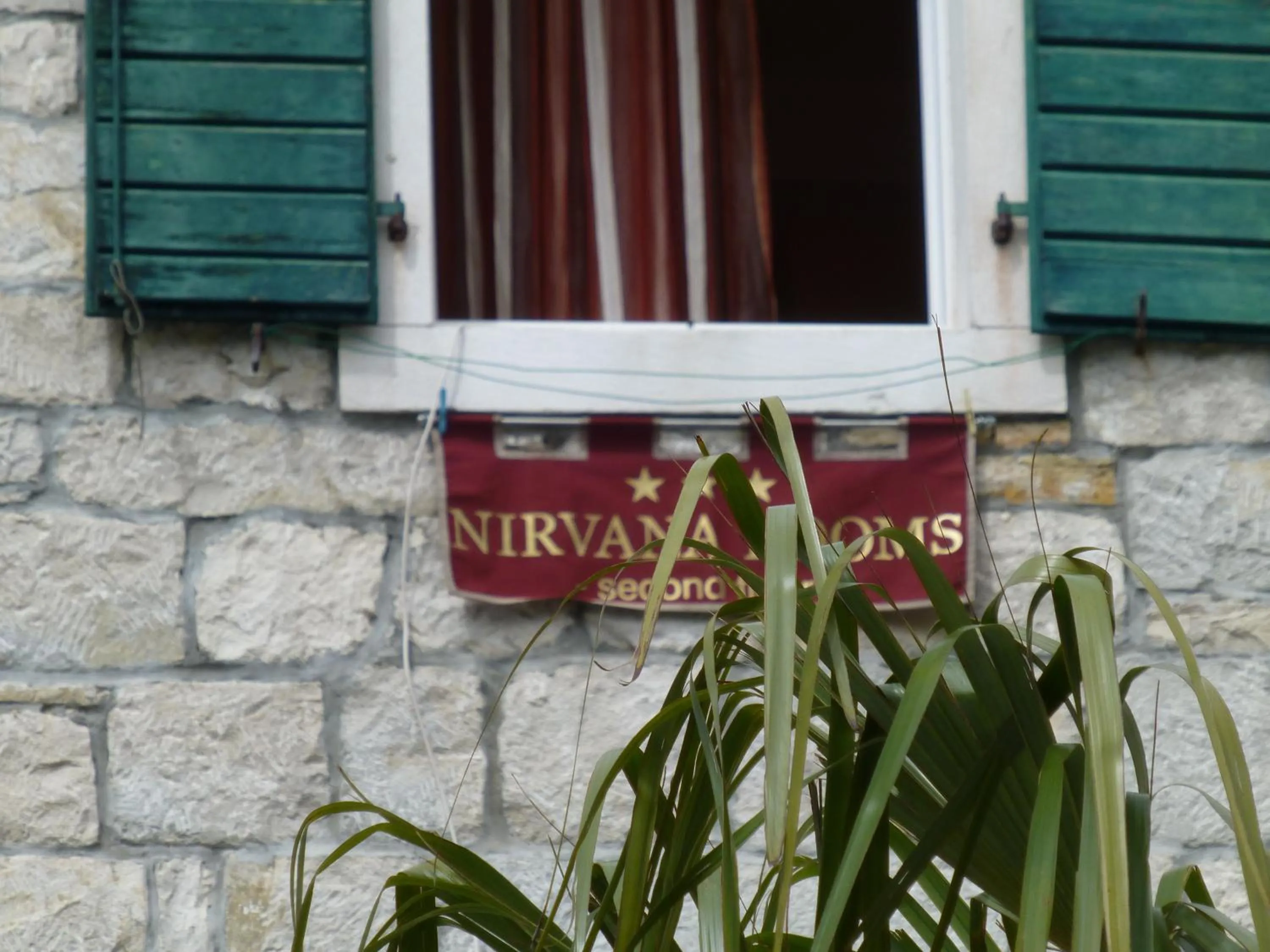 Property logo or sign in Nirvana Rooms & Apartments