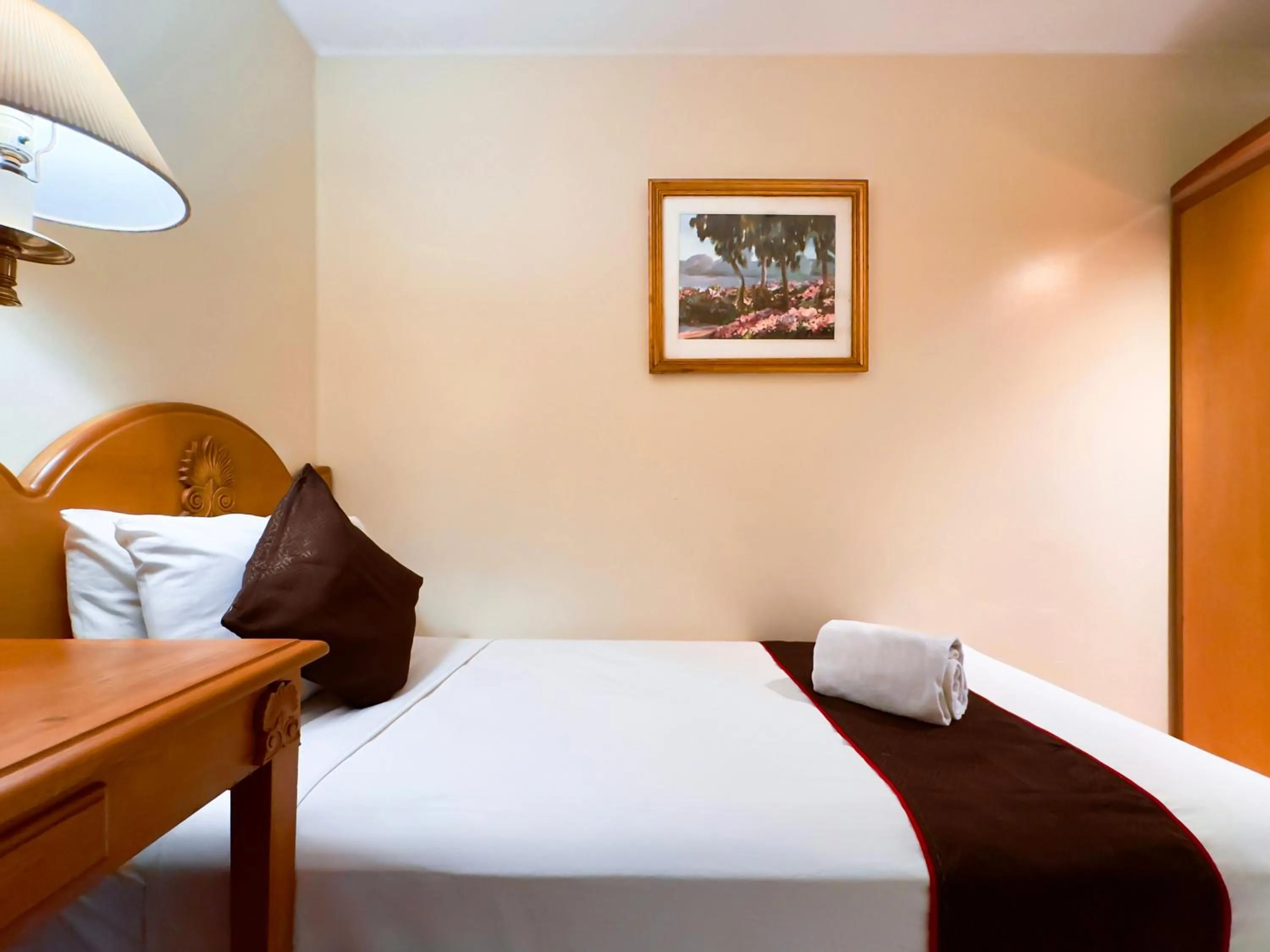 Bed in Palladium Suites Hotel