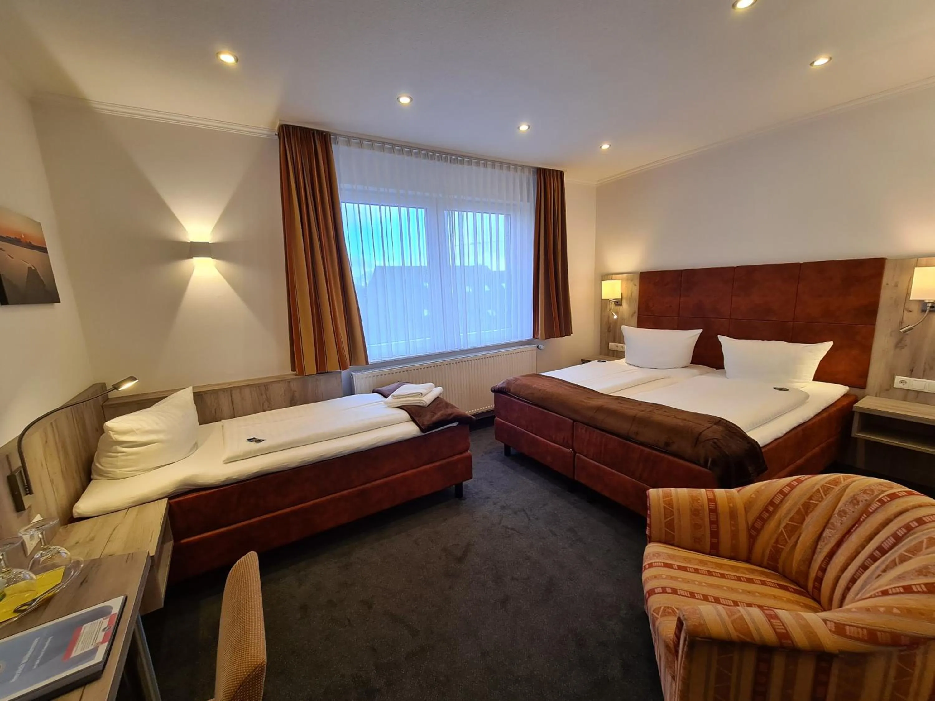 Photo of the whole room, Bed in WH Hotels Papenburg Zentrum