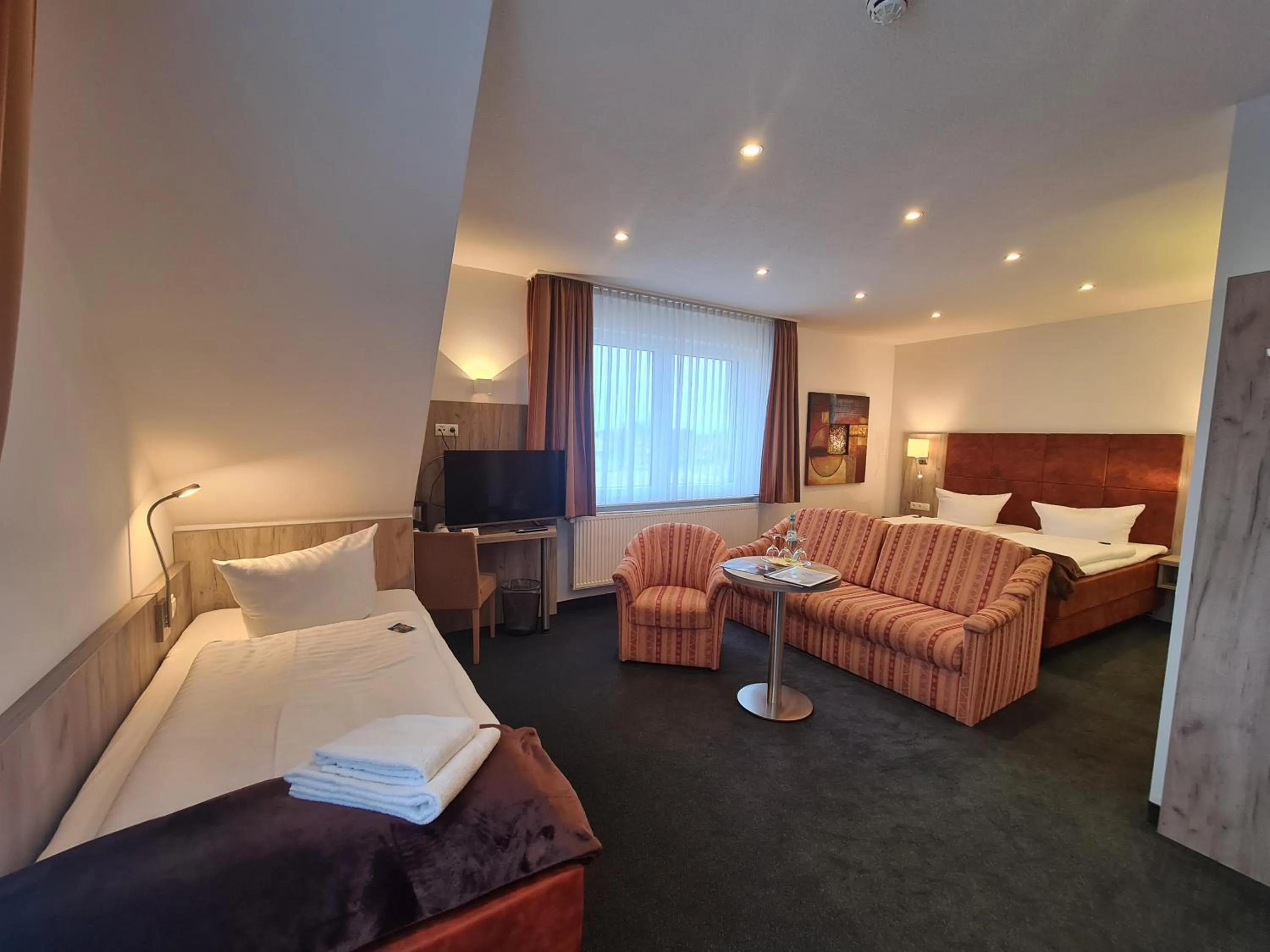 Photo of the whole room, Bed in WH Hotels Papenburg Zentrum