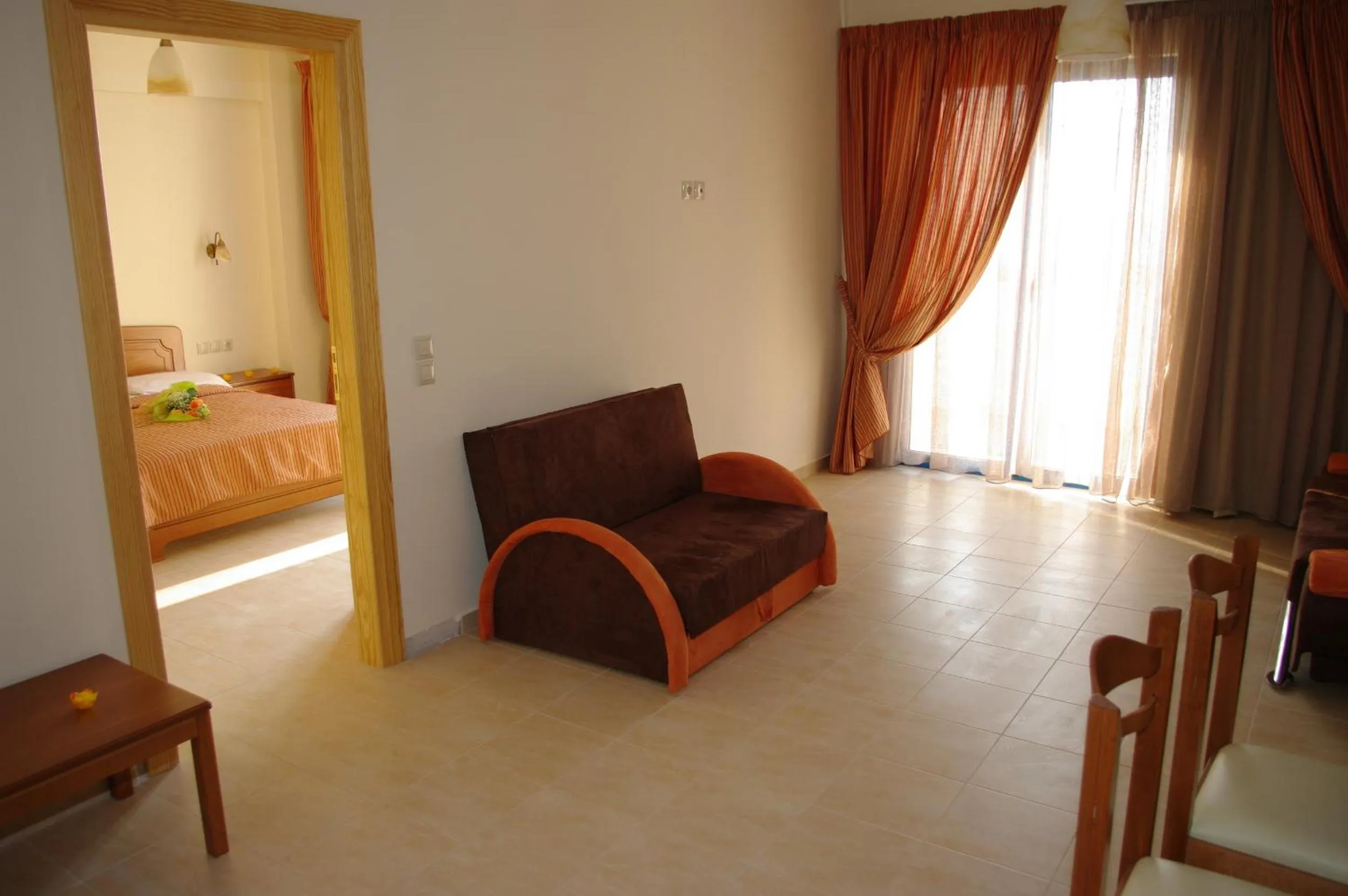 Seating area, Bed in Gold Apartments