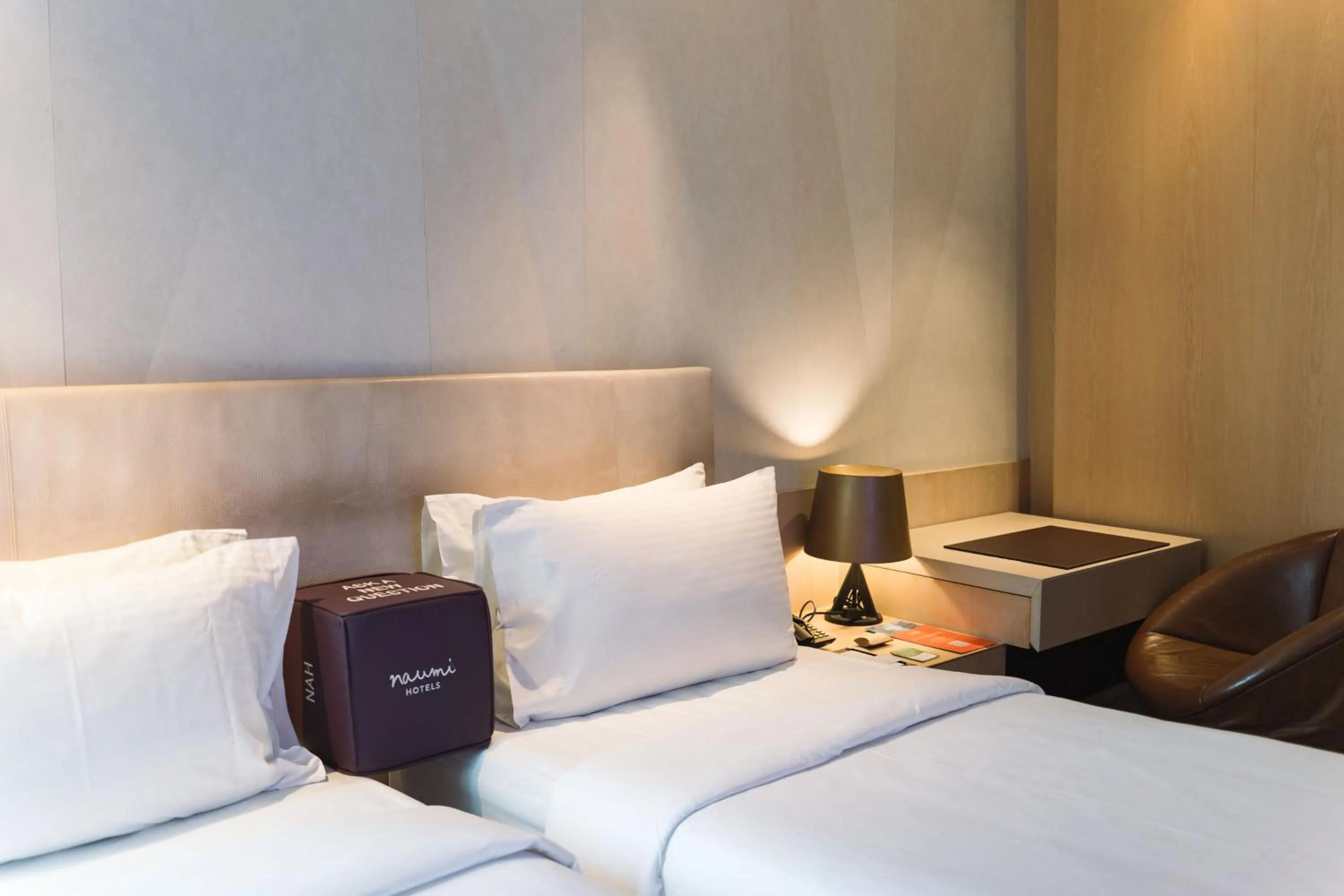 Bed in Naumi Hotel Singapore