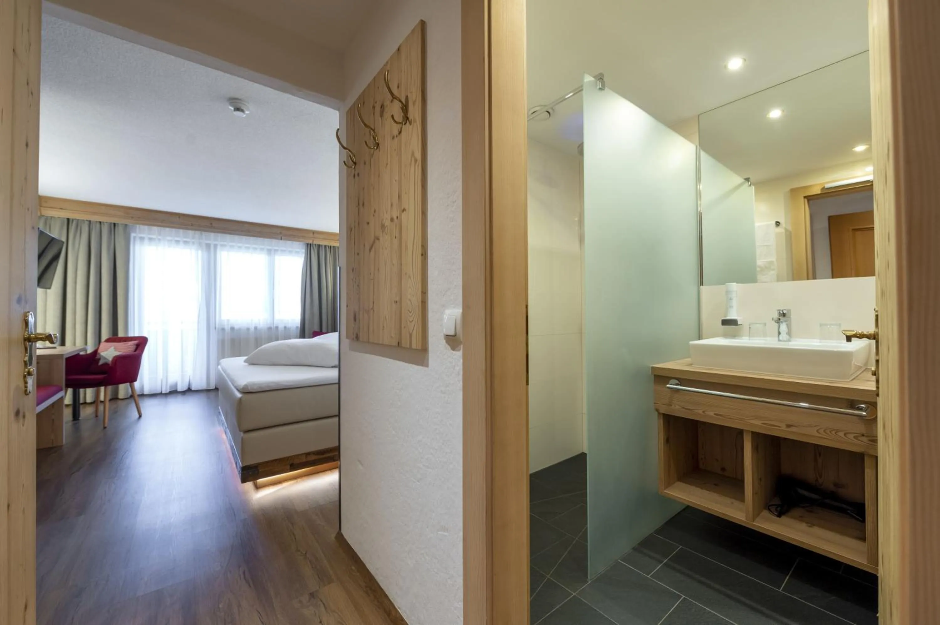 Bathroom, Bed in Hotel Bergkristall