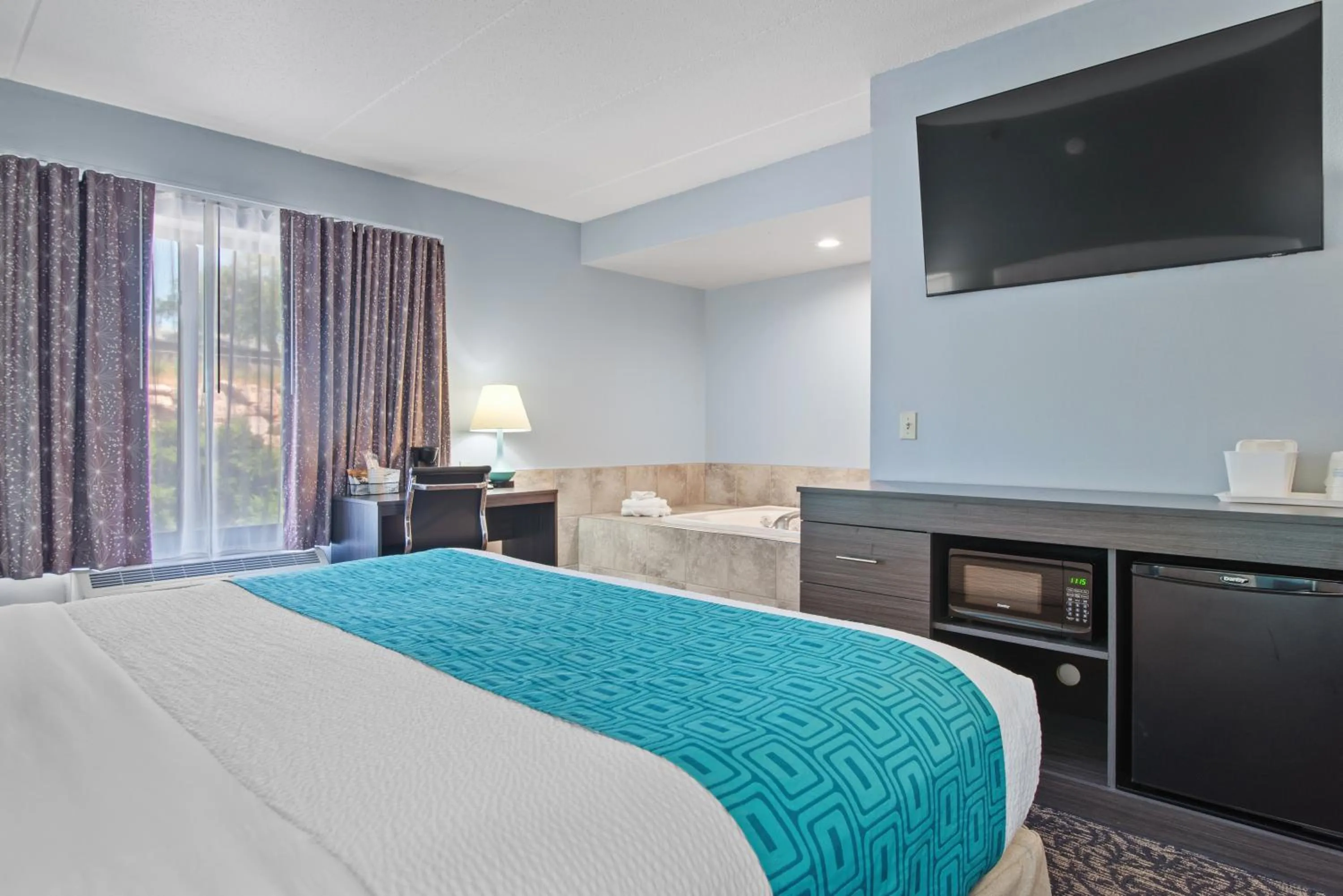 Bed in Elevation Inn & Suites, Trademark Collection by Wyndham