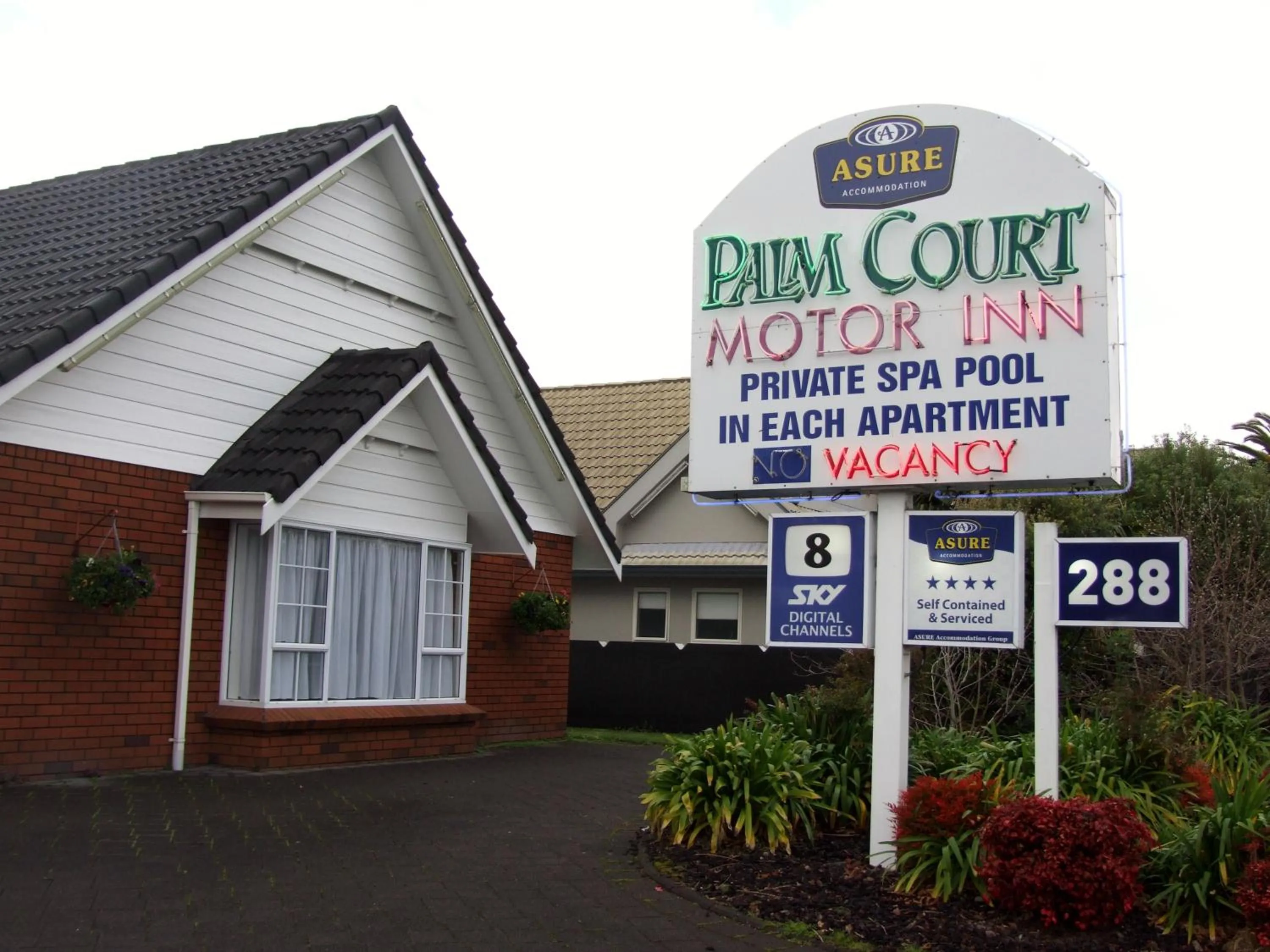 Property logo or sign in Palm Court Motor Inn