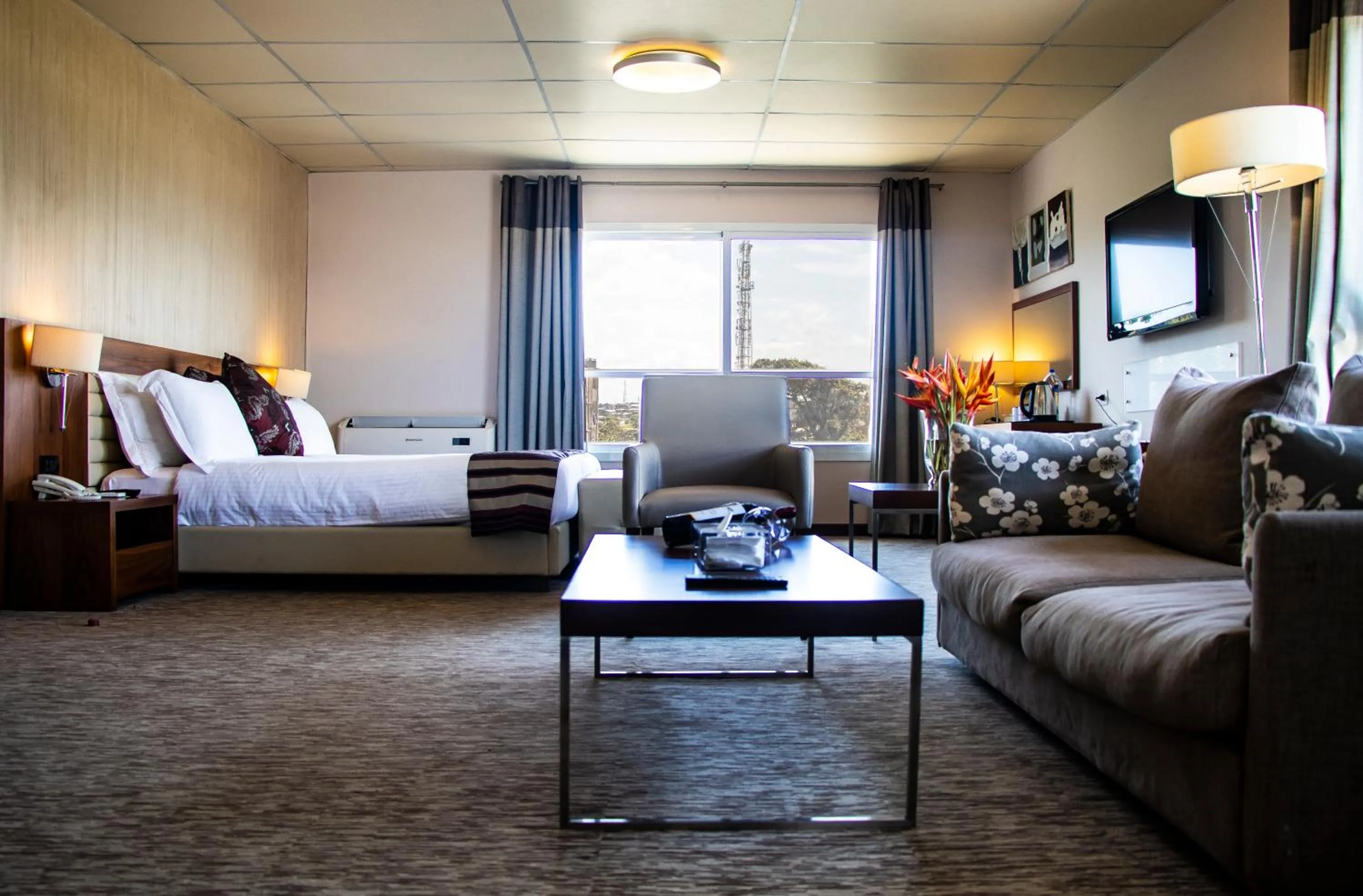 Living room, Bed in Mamba Point Hotel