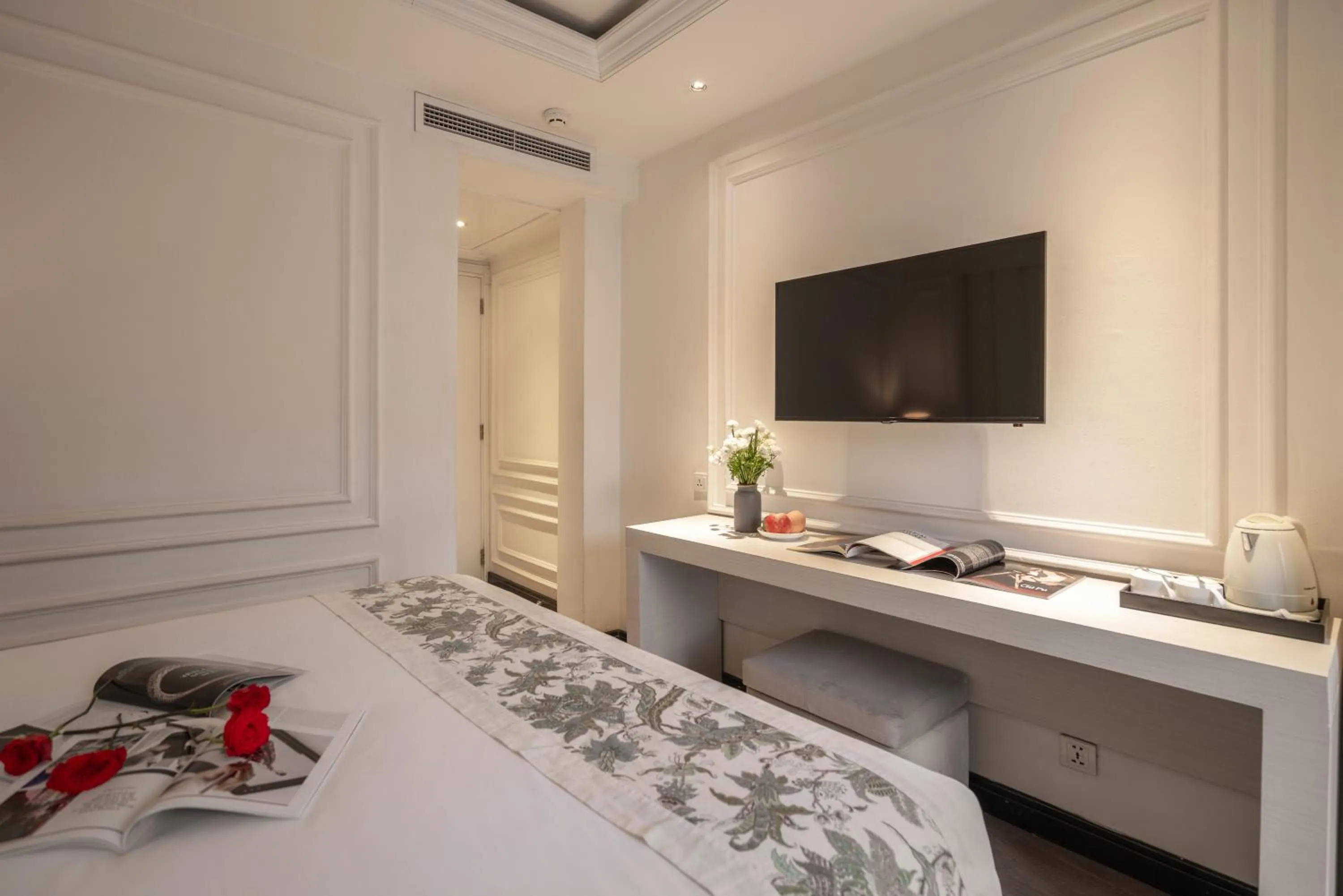 Bed in A&EM Saigon Hotel