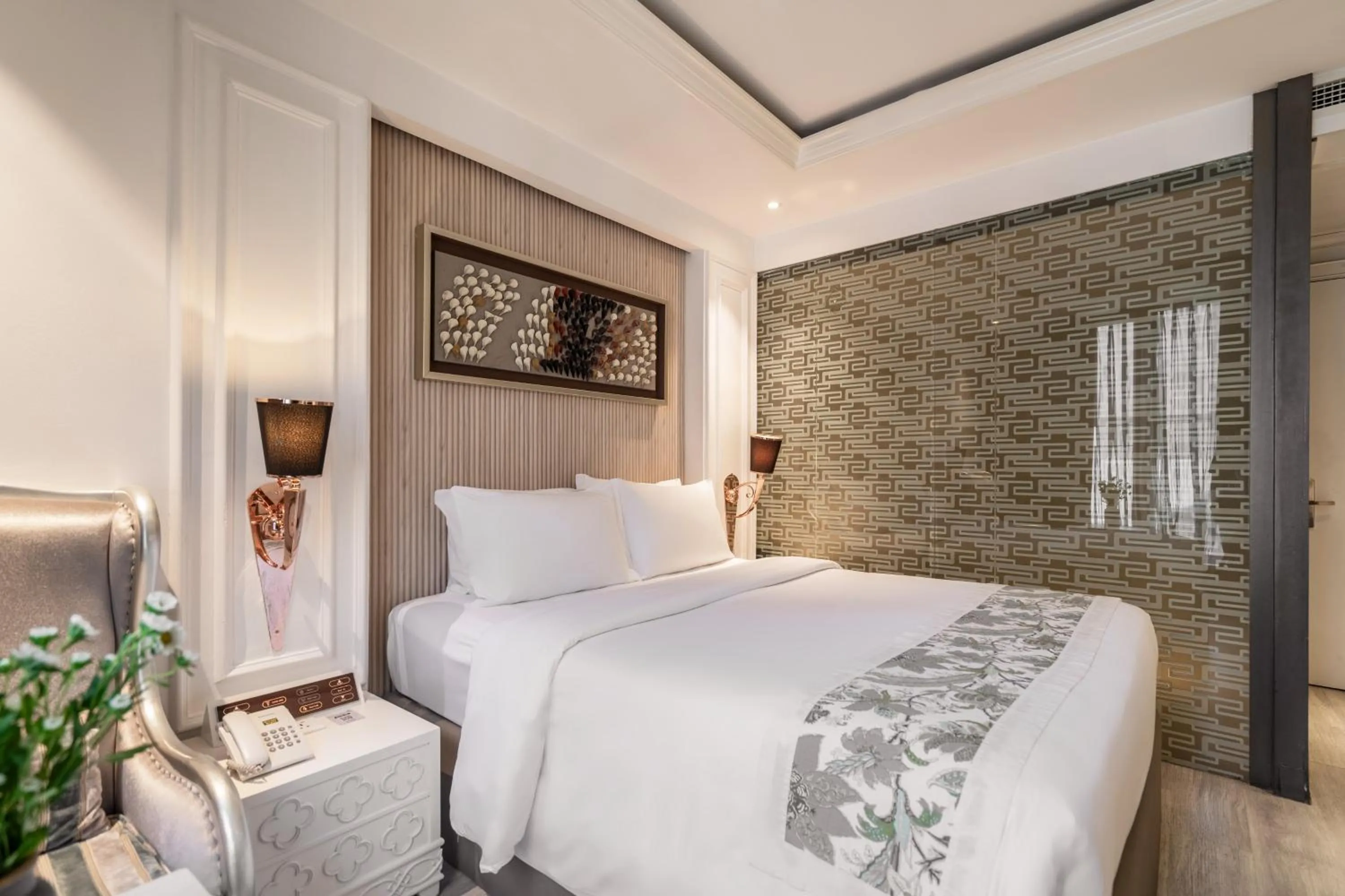 Bed in A&EM Saigon Hotel