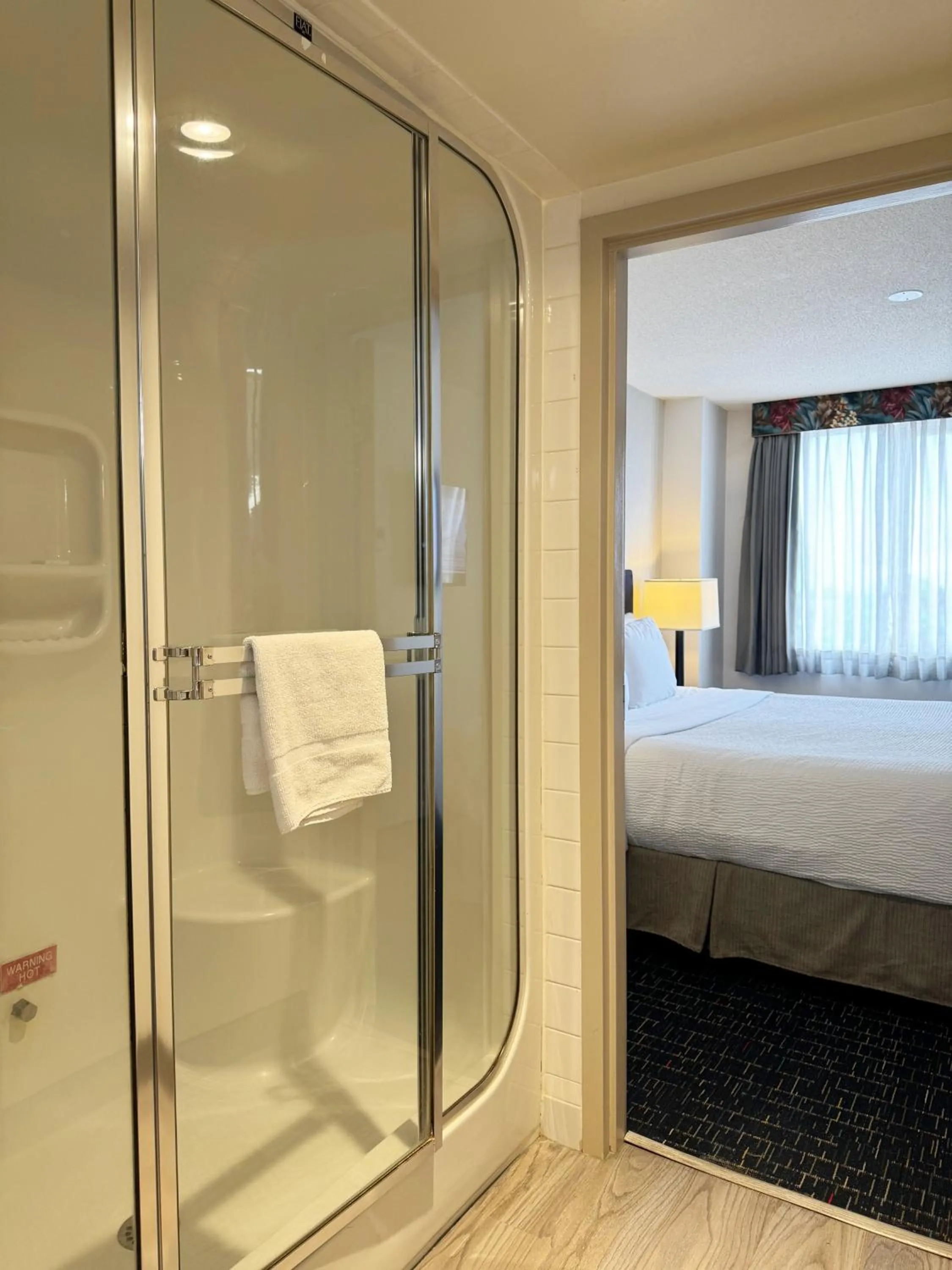 Shower, Bed in Divya Sutra Plaza and Conference Centre Calgary Airport