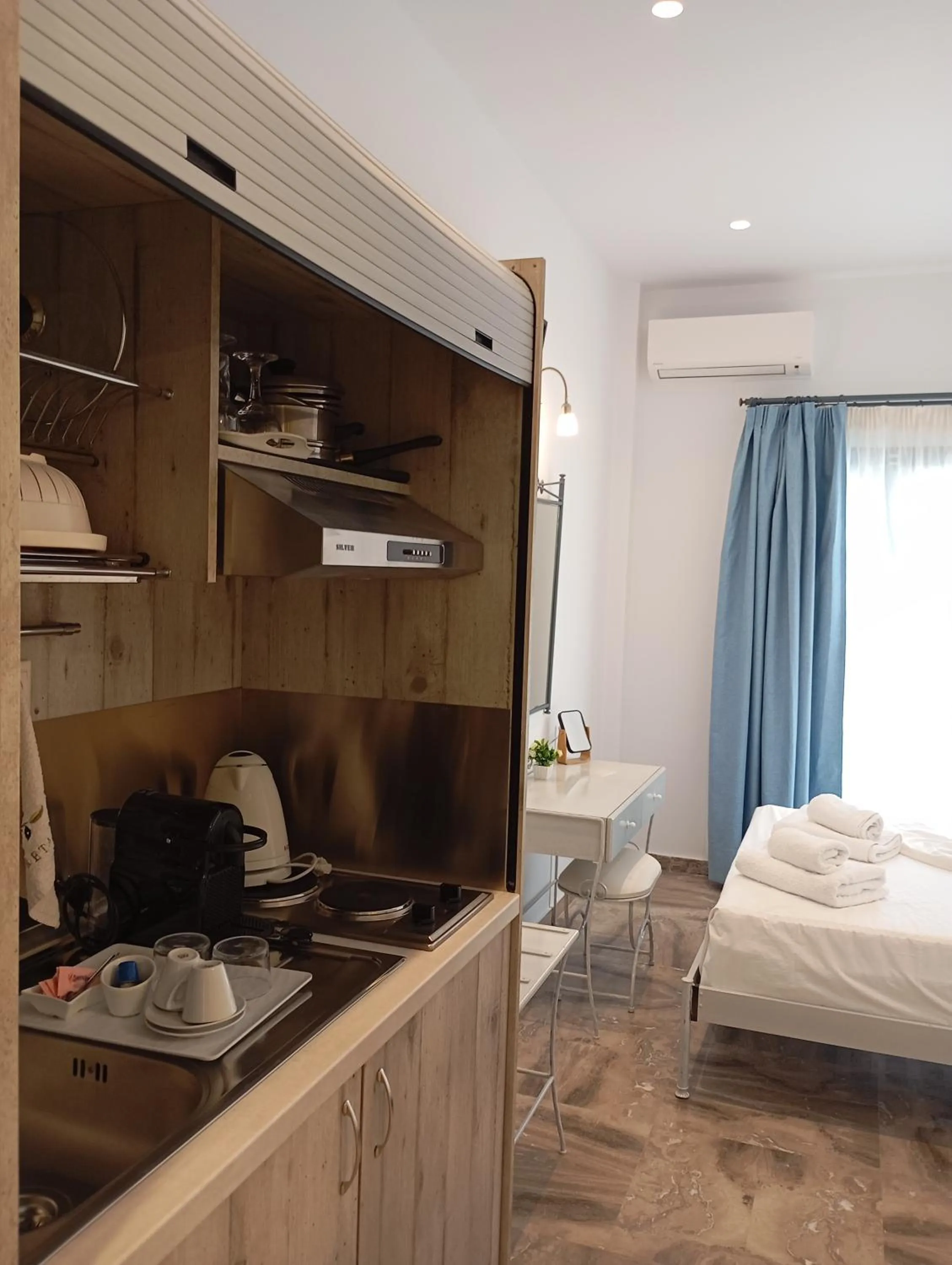 Kitchen or kitchenette, Bed in Ifestia Hotel