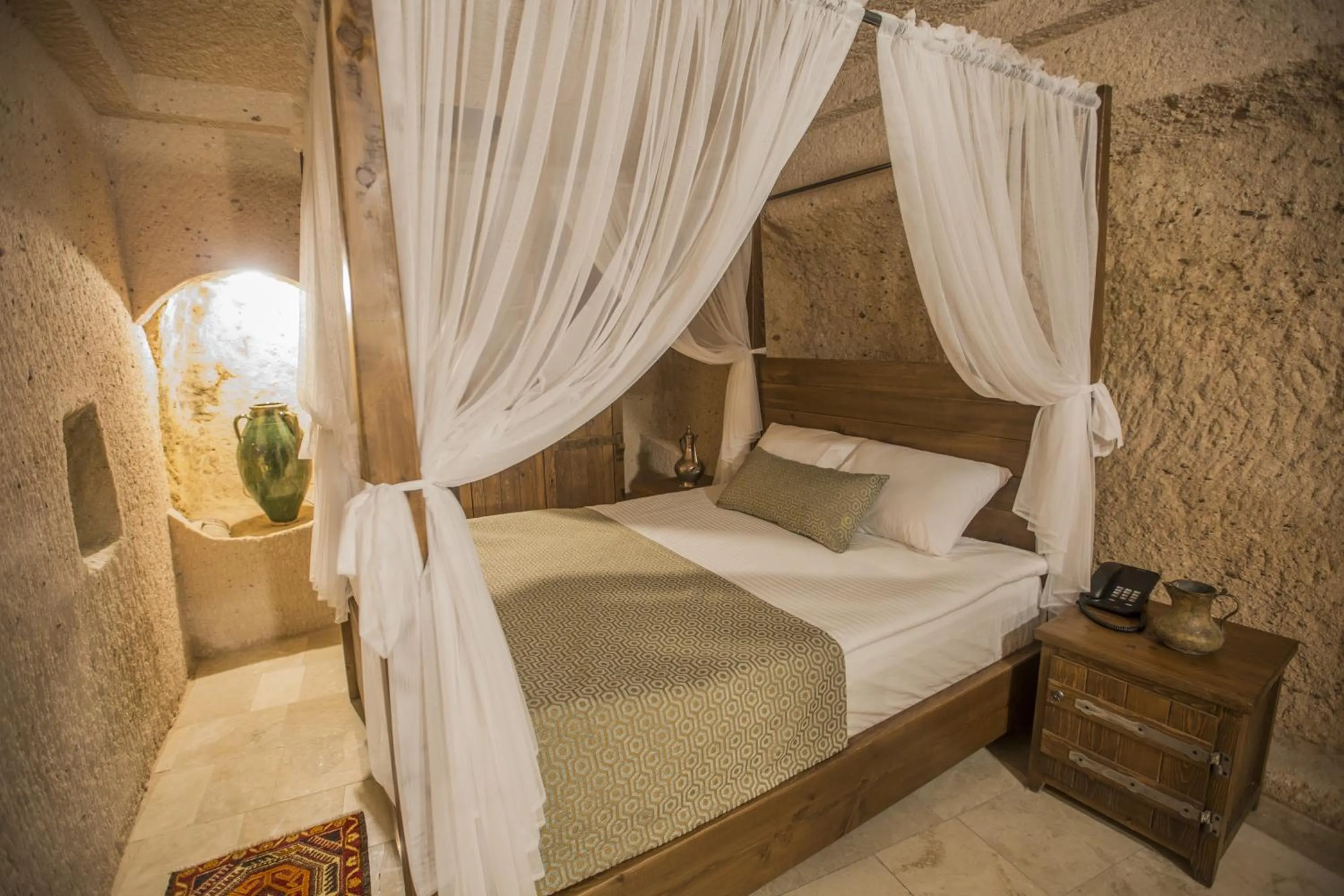Bed in Helike Cave Suites