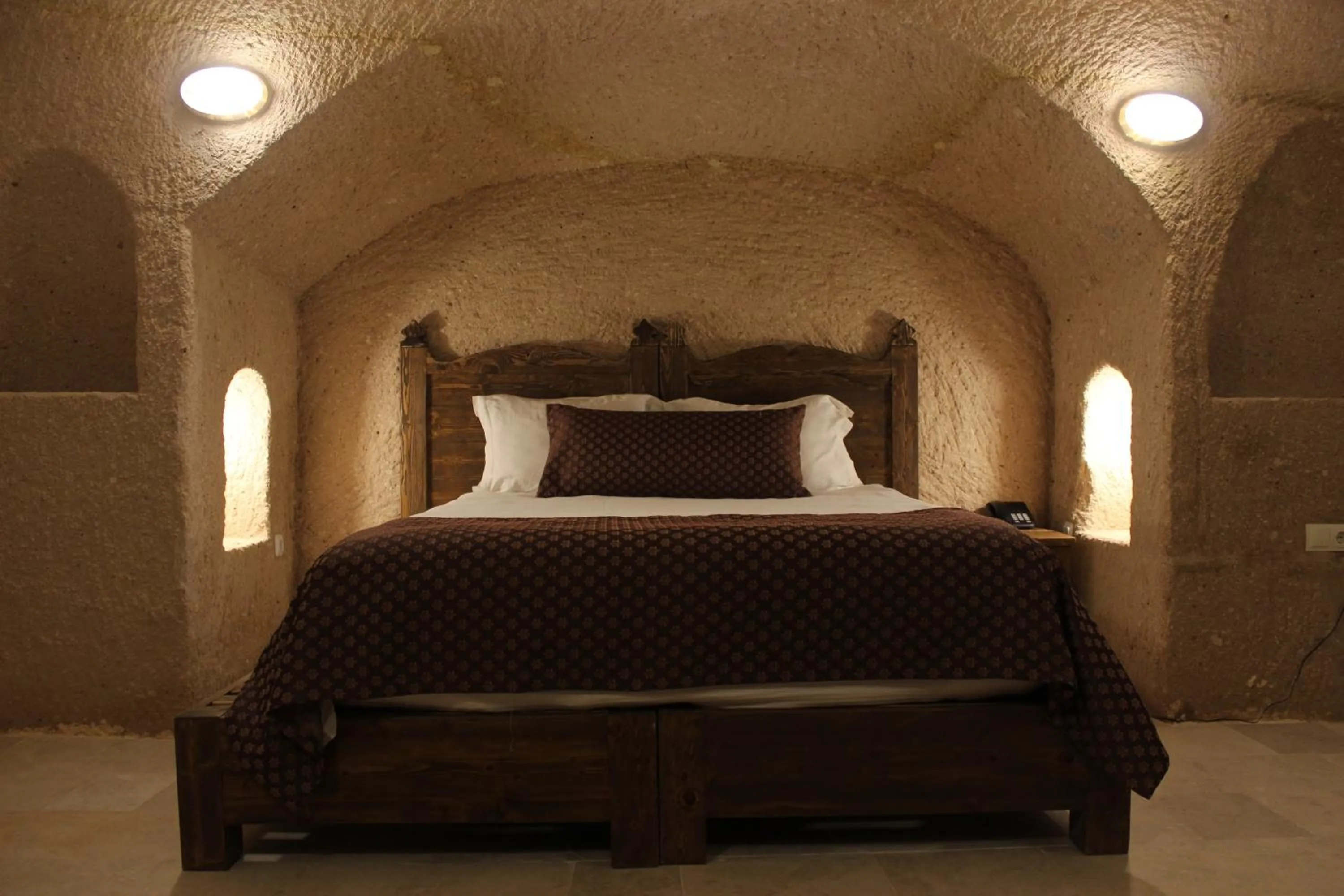 Bed in Helike Cave Suites