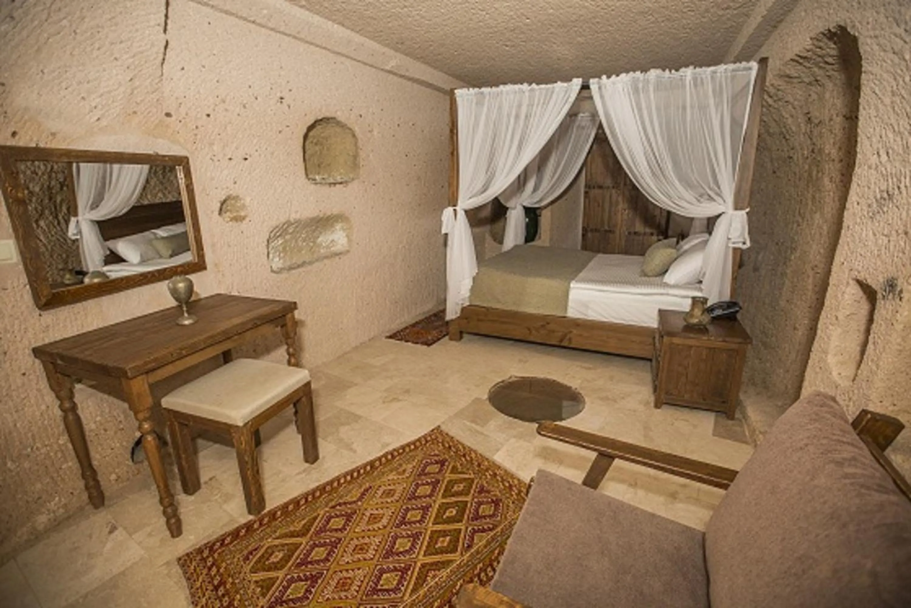 Bed in Helike Cave Suites