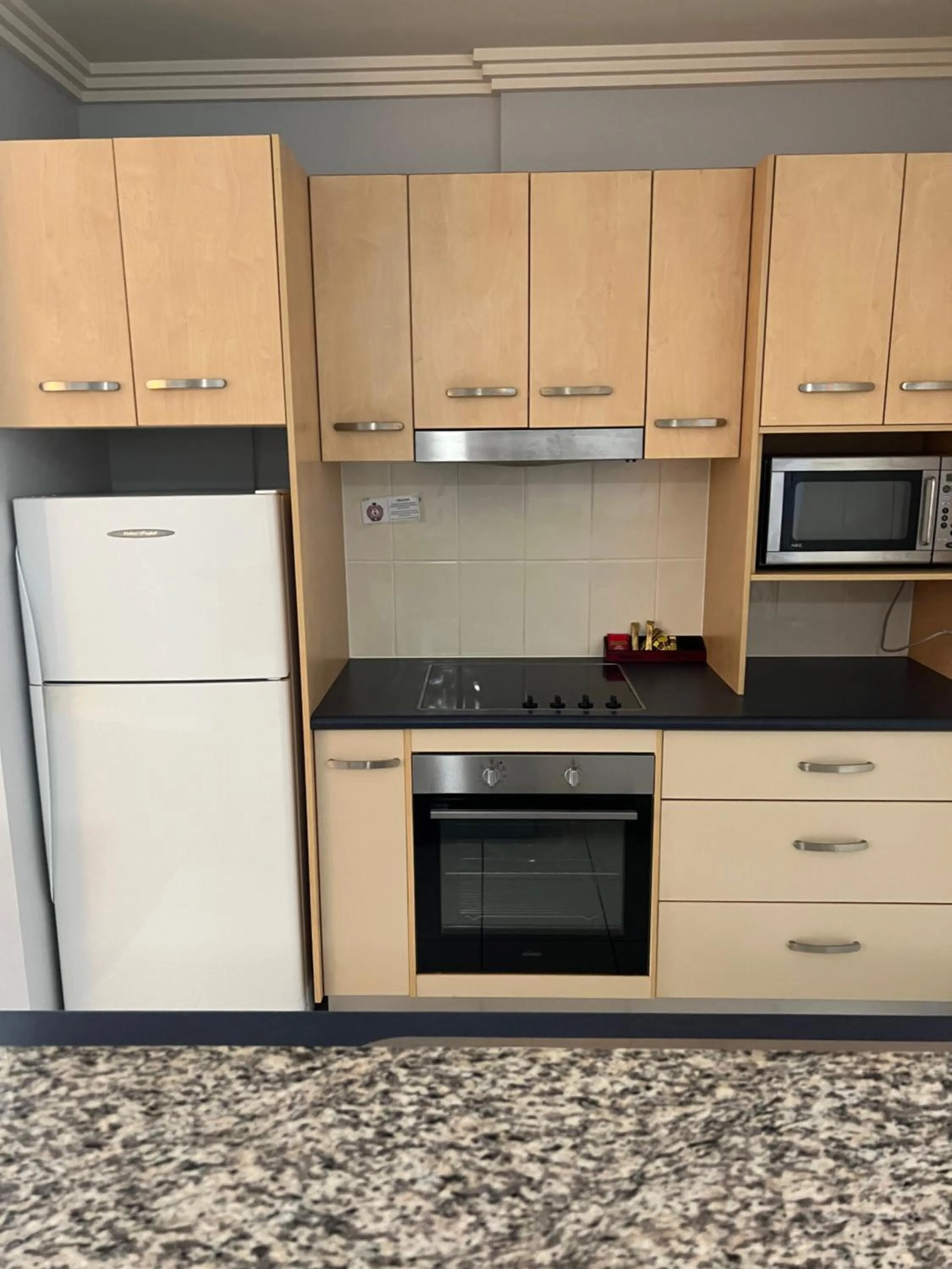 Kitchen or kitchenette in Caloundra Central Apartment Hotel Official