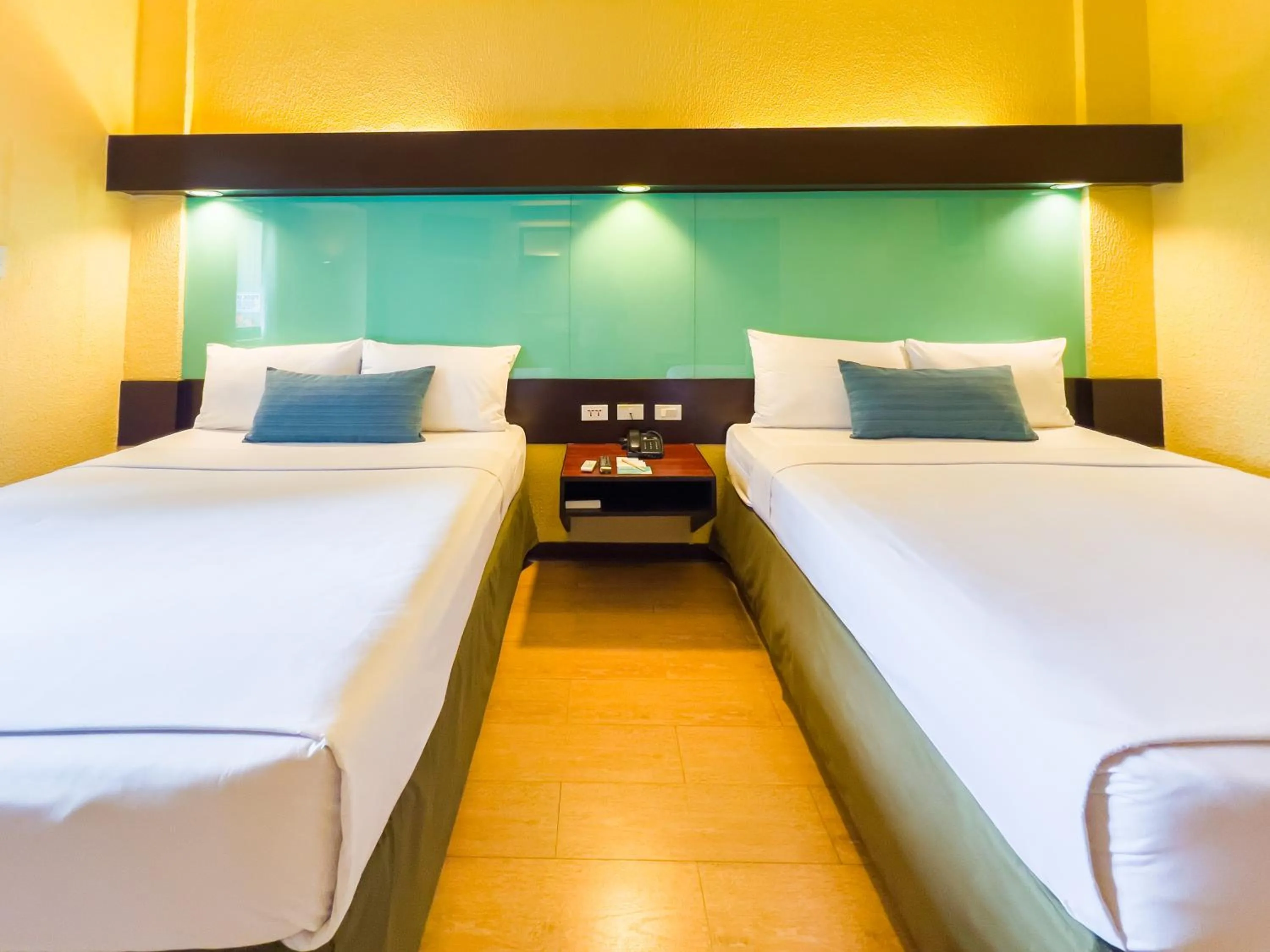 Bed in Microtel by Wyndham Cabanatuan