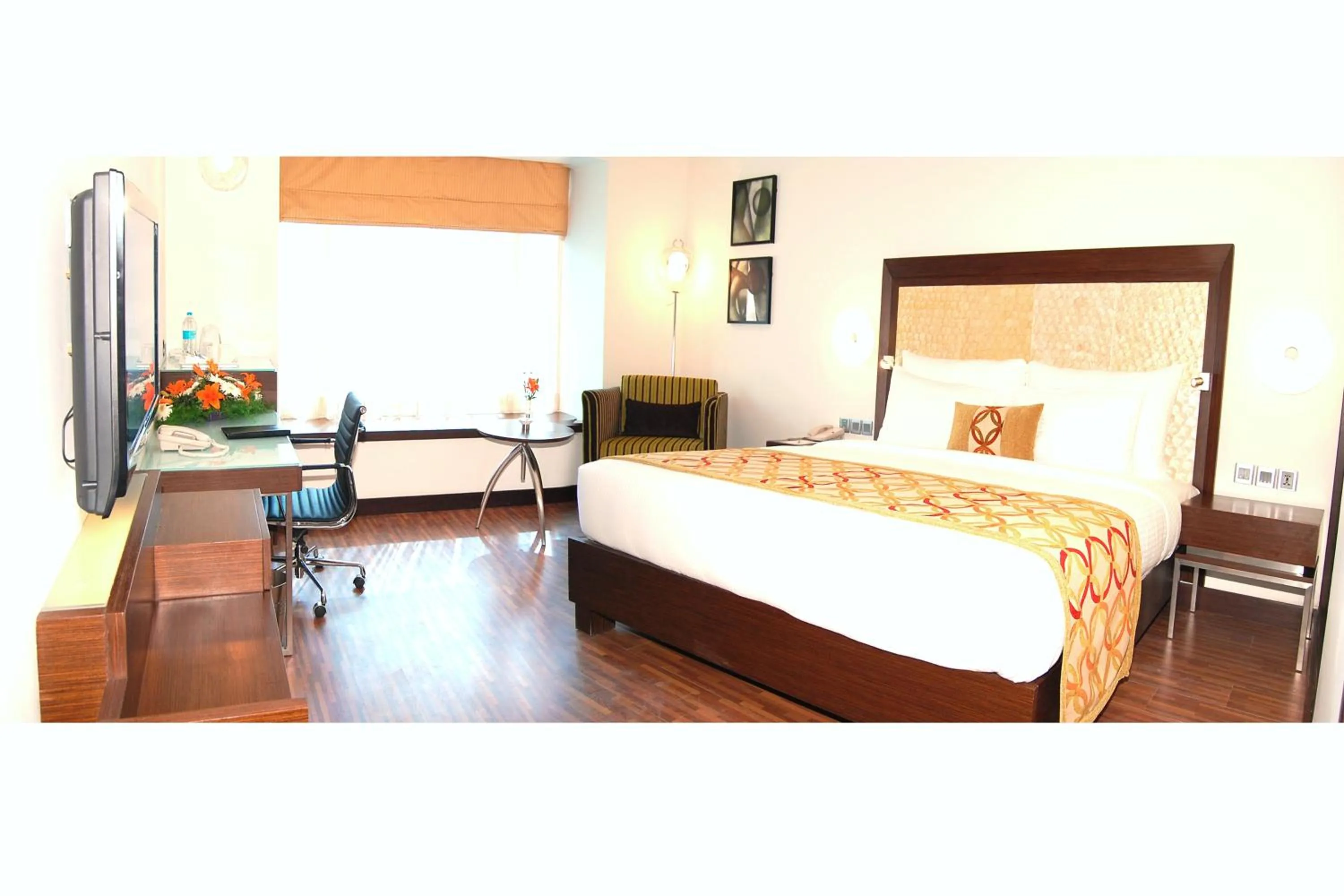 Seating area, Bed in Pride Premier Bengaluru